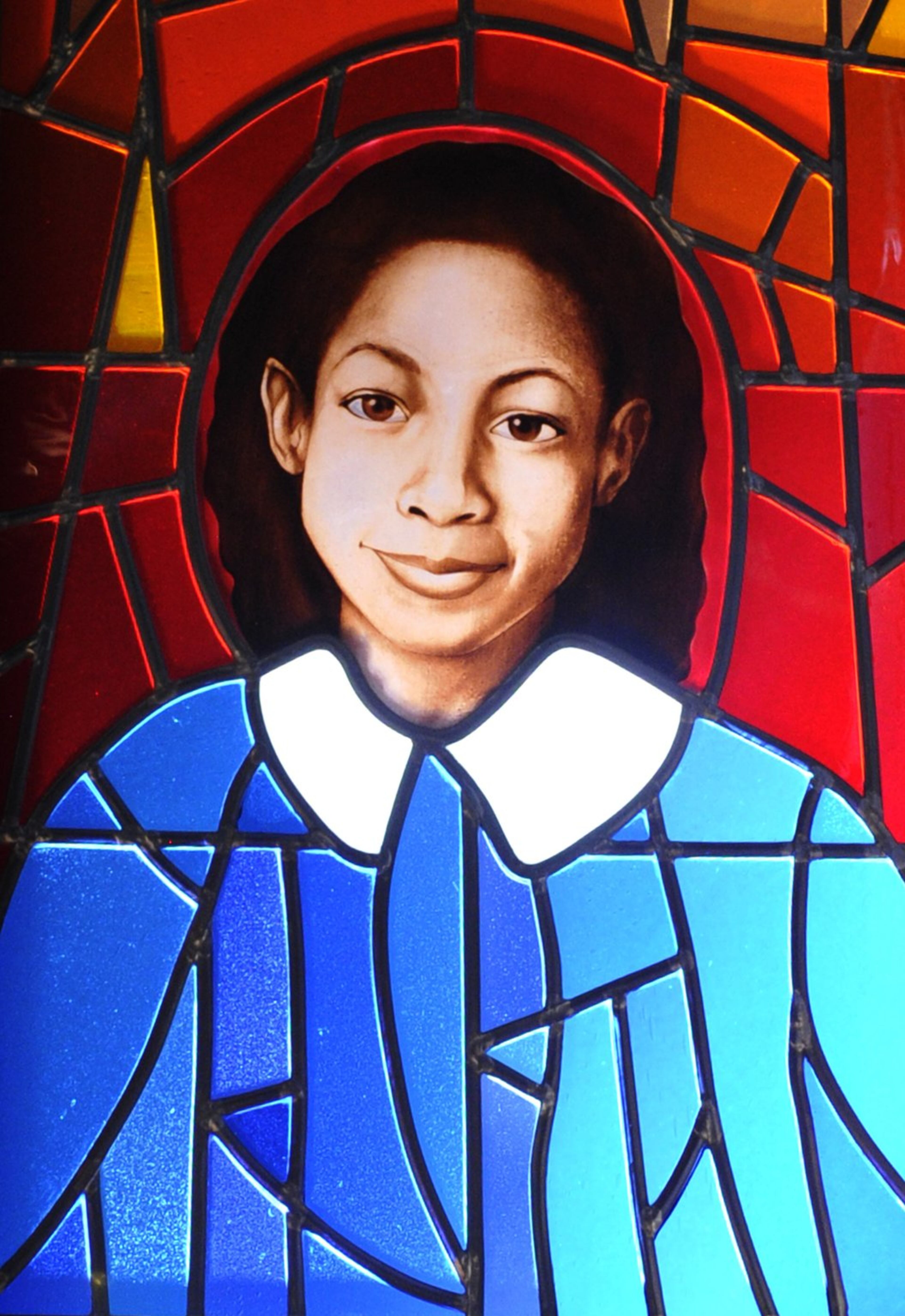 A stained-glass portrait of Denise McNair, one of the four young girls killed in the Birmingham church bombing of 1963, hangs at the National Center for Civil and Human Rights in Atlanta.. David Tulis / AJC Special
