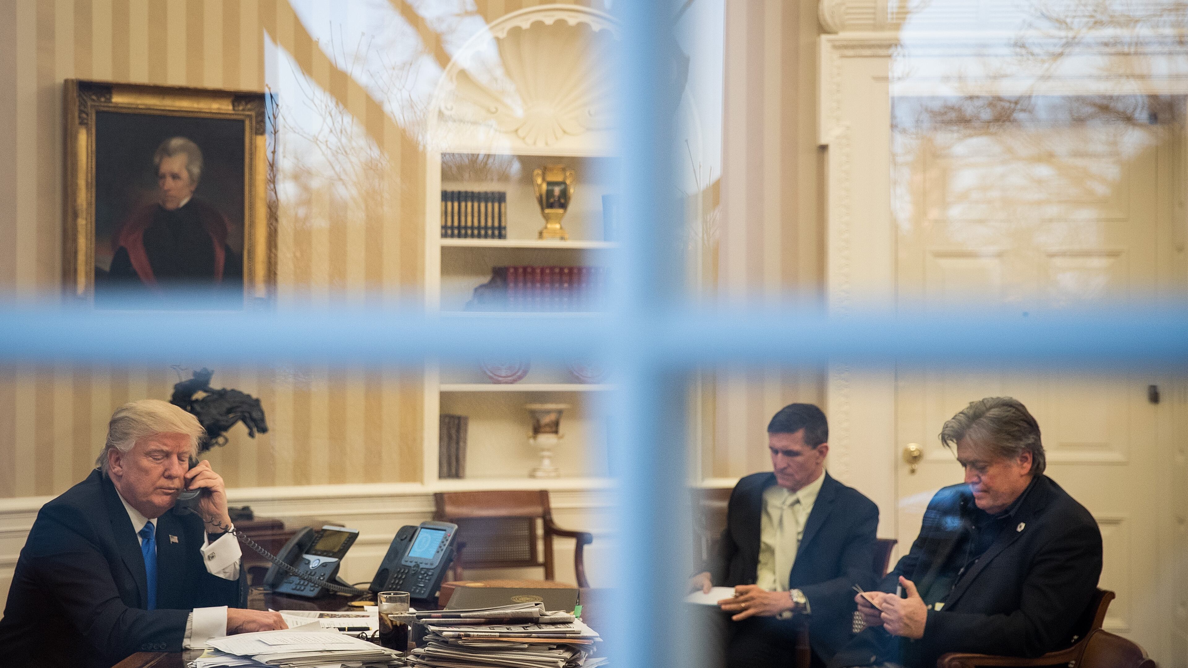 President Donald Trump speaks on the phone Saturday with Australian Prime Minister Malcolm Turnbull in the Oval Office – in the company of national security advisor Michael Flynn and White House chief strategist Steve Bannon. Drew Angerer/Getty Images