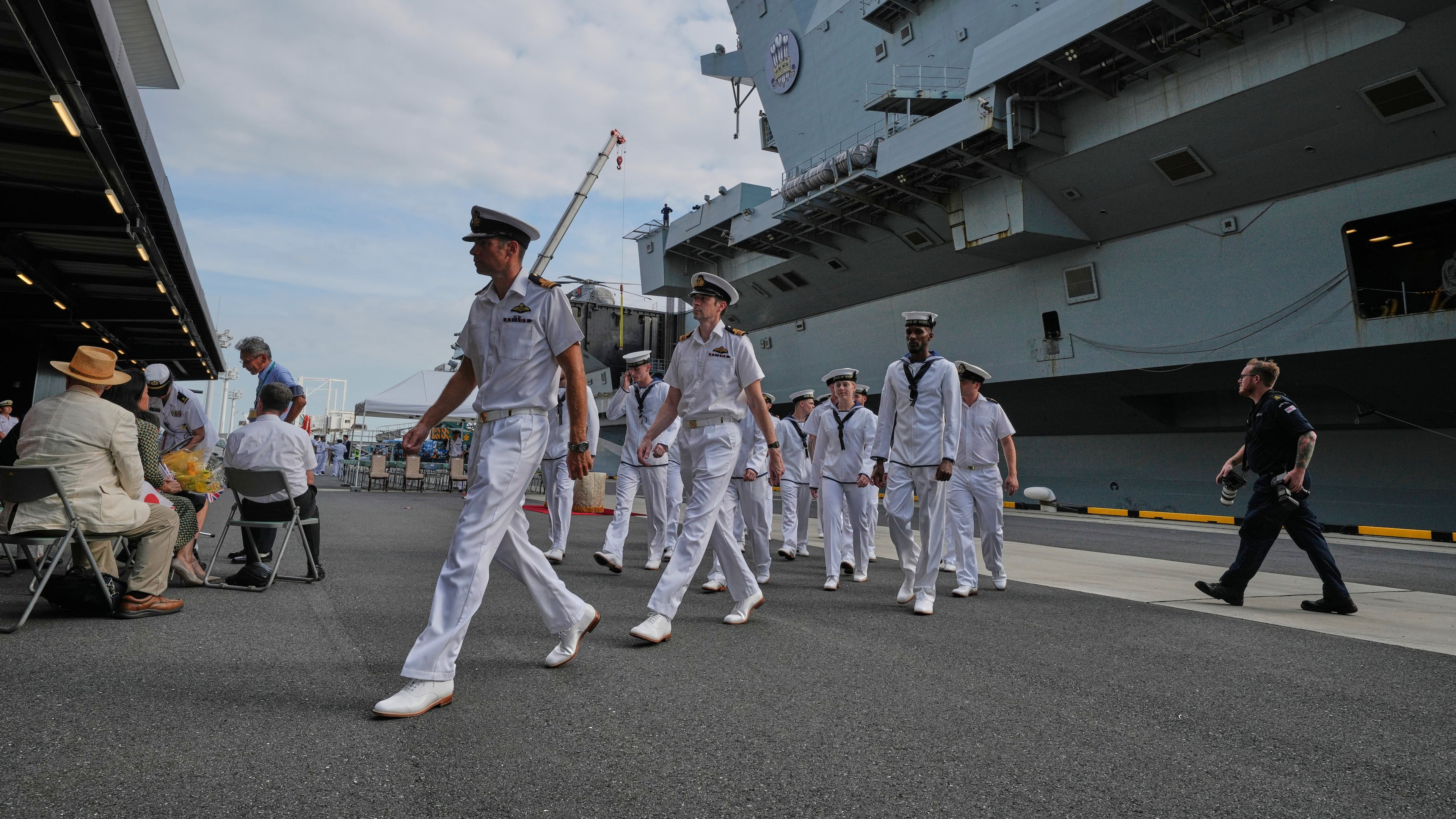 FILE - Crews walk near the Royal Navy aircraft carrier HMS Prince of Wales before its port call in Tokyo Thursday, Aug. 28, 2025. (AP Photo/Eugene Hoshiko, File)