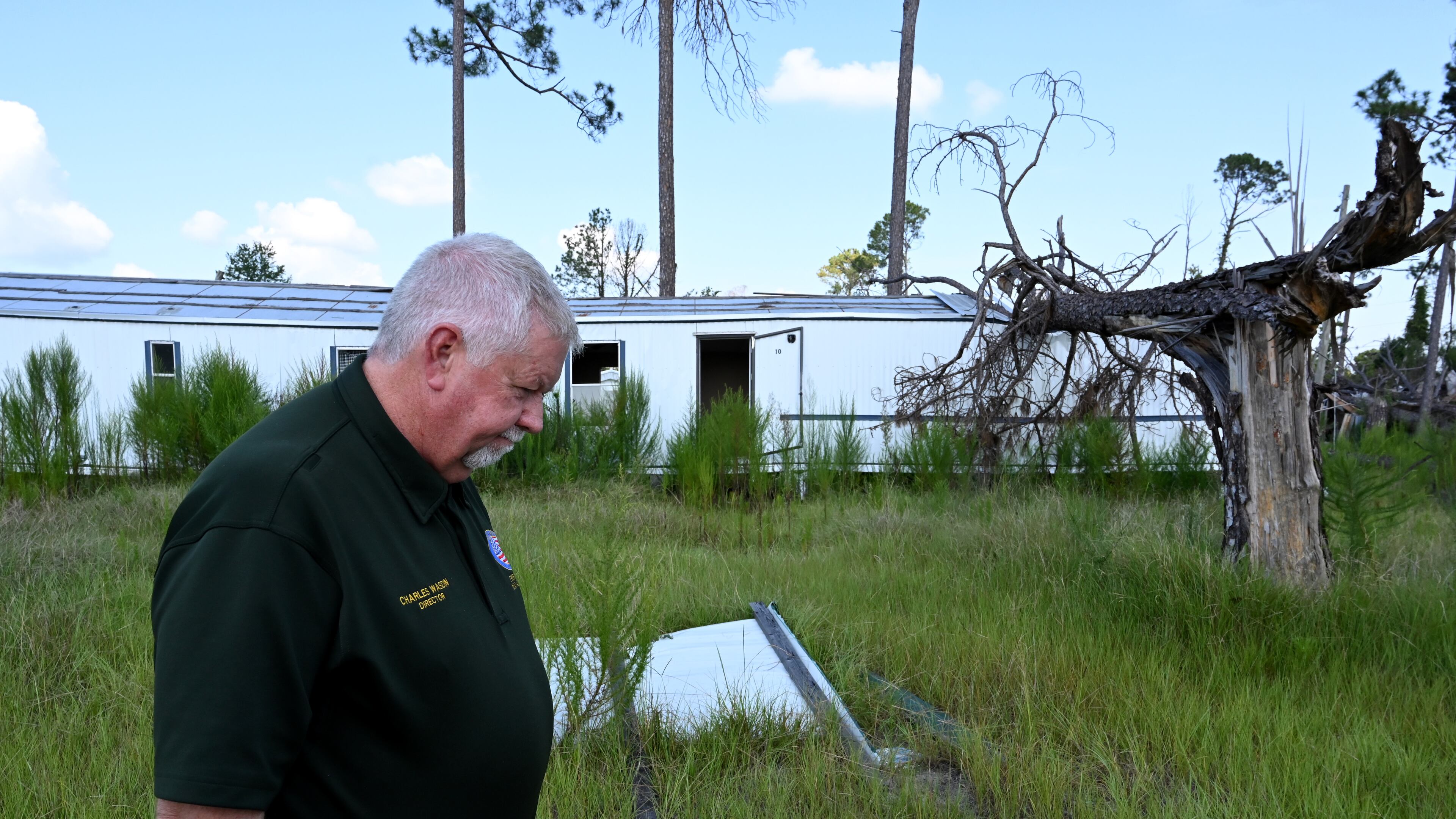Charles Wasdin, Jeff Davis County's fire chief and director of emergency management, pauses as he shows a destroyed mobile home community in Hazlehurst on Thursday, Aug. 21, 2025, almost a year after Hurricane Helene. (Hyosub Shin/AJC)