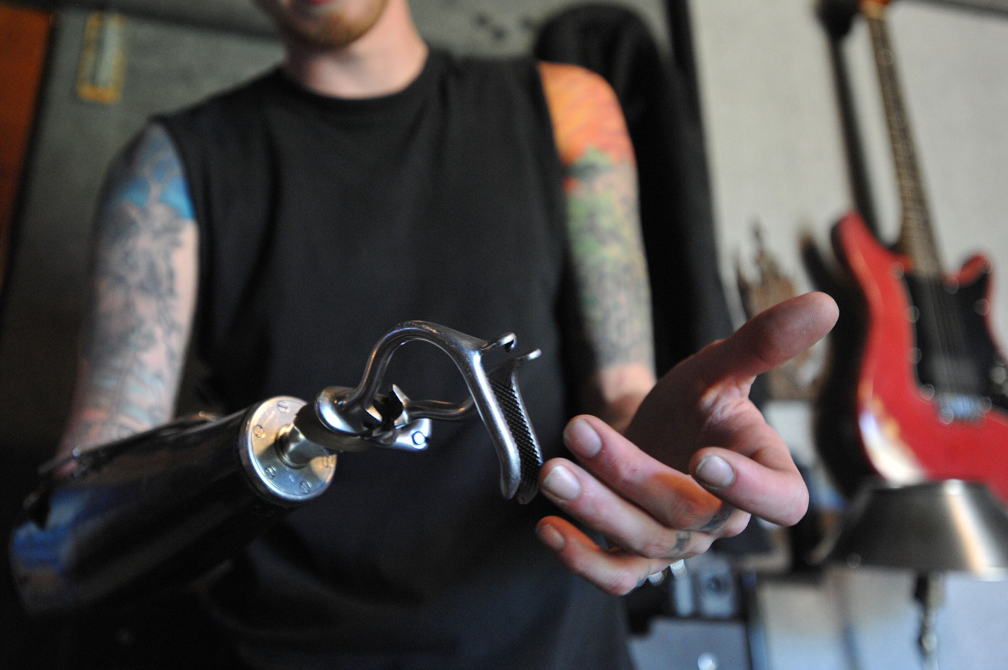 Aspiring musician Jason Barnes, a drummer who lost his right hand in an accident, practices and relaxes at his house on Tuesday April 1, 2014 in Locust Grove, Ga. David Tulis / AJC Special