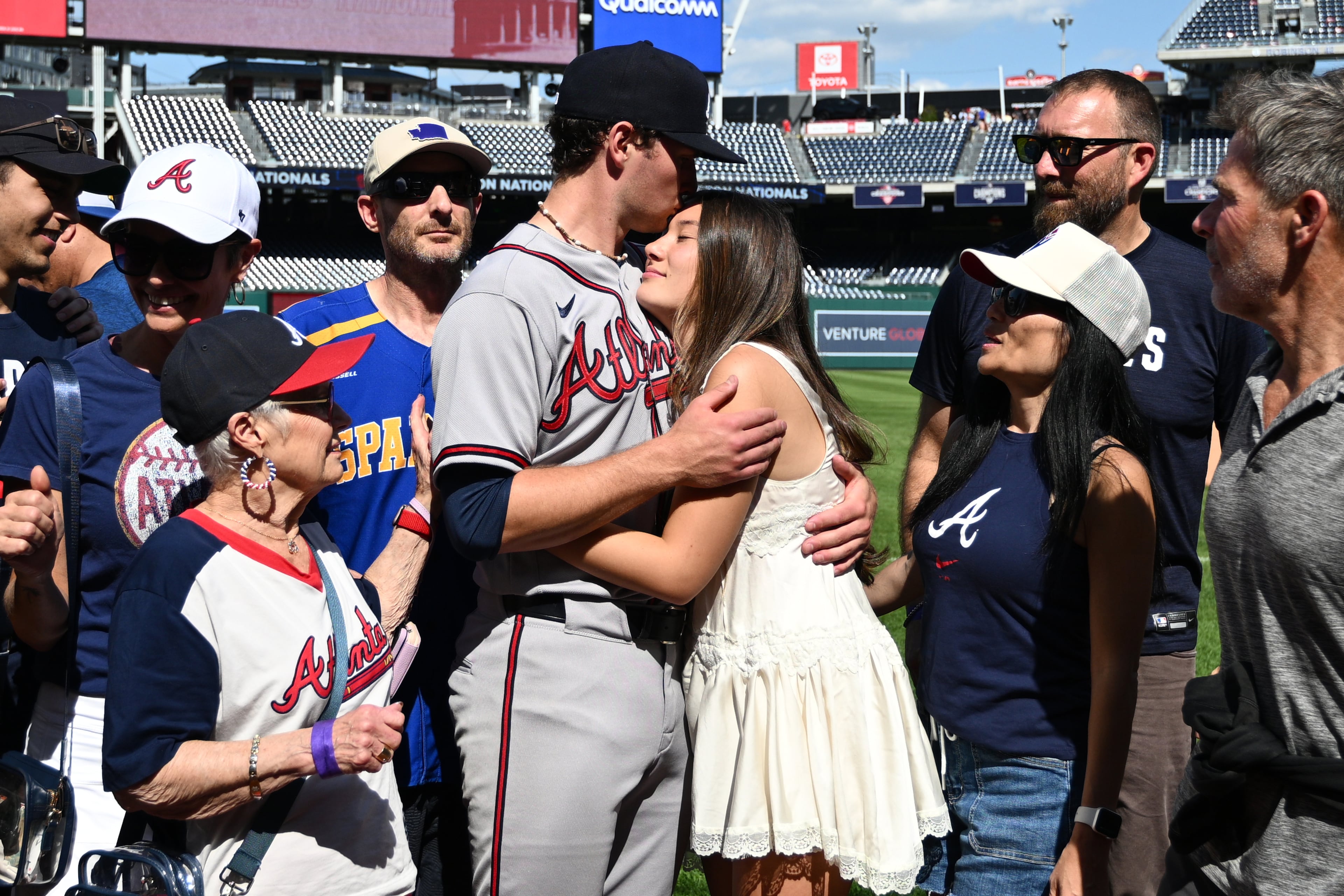Braves pitcher JR Ritchie hugs fiancee Makena Miller after winning his MLB debut at Truist Park. (Nick Wass/AP)