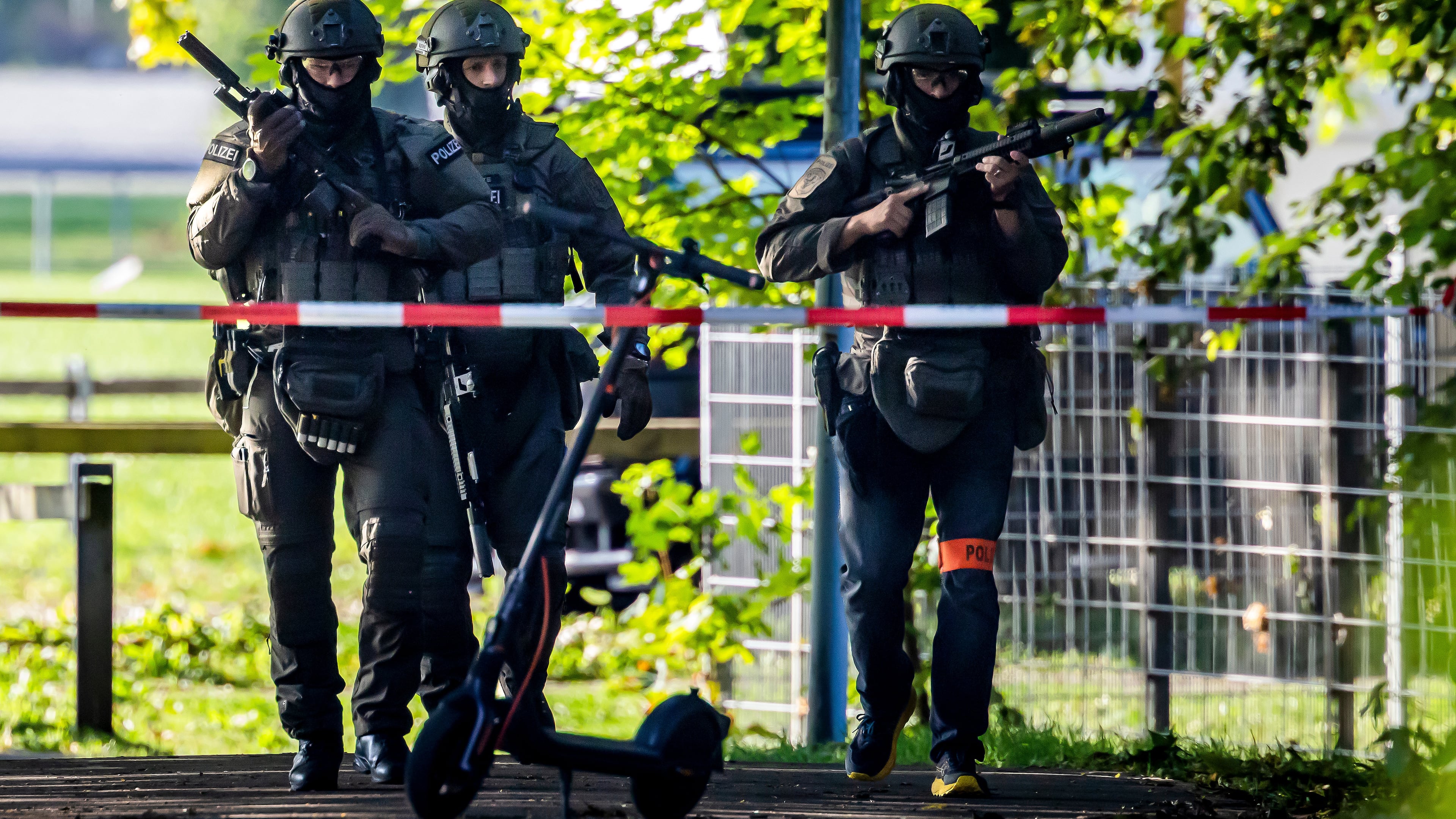 Armed police officers patrol near the Schachen horse racing track in Aarau following a shooting during a rave event near Aarau, Switzerland, Sunday, Aug. 30, 2026. (Michael Buholzer/Keystone via AP)