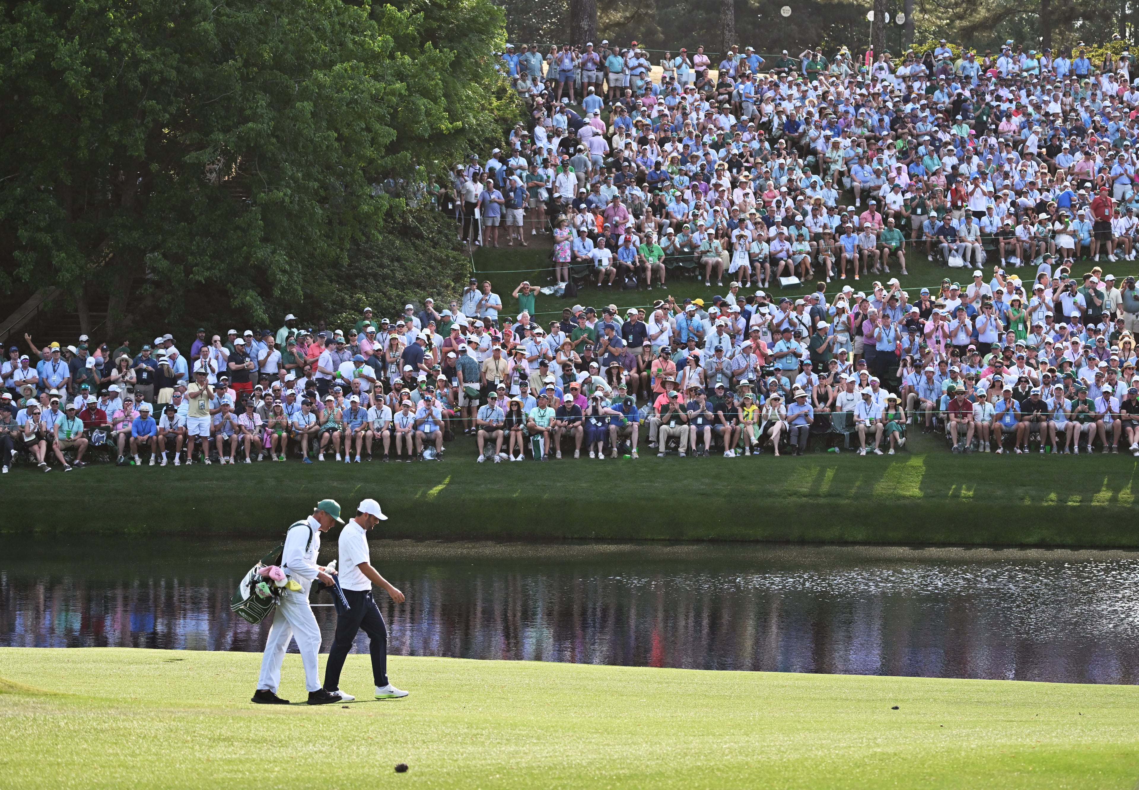 Scottie Scheffler and caddie Ted Scott walk to 16th tee after a birdie on 15 during final round of the Masters, at Augusta National Golf Club, Sunday, April 12, 2026, in Augusta, GA (Hyosub Shin/AJC)