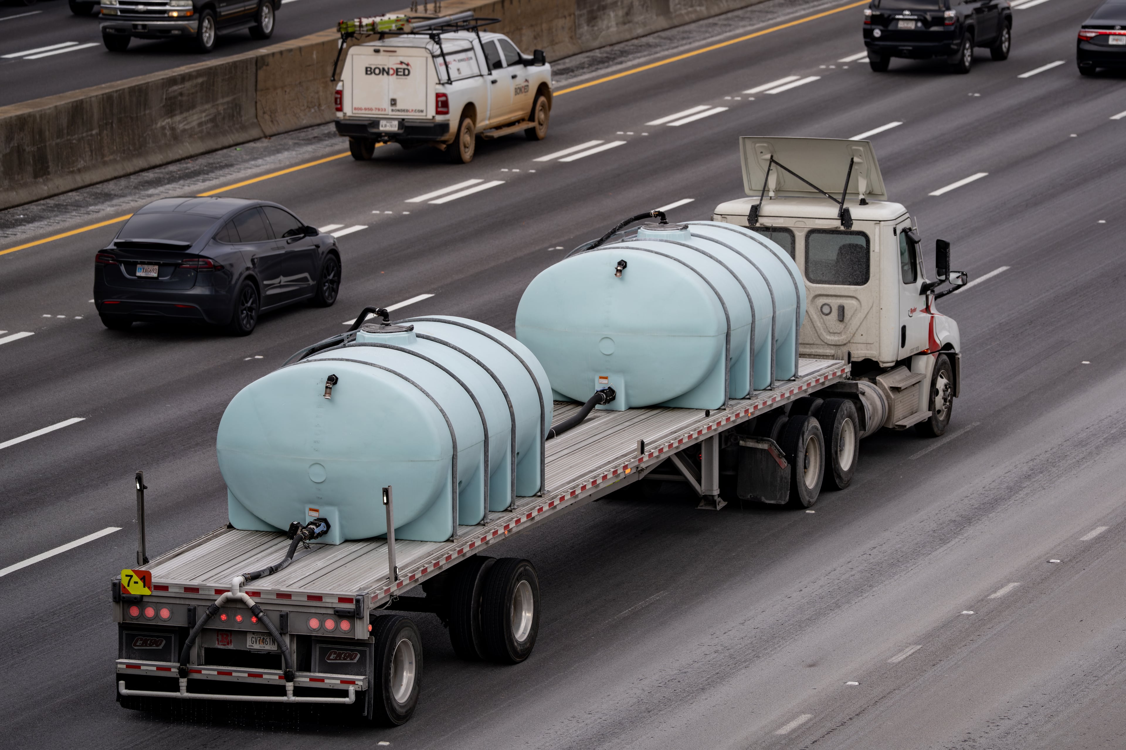 A convoy of Georgia Department of Transportation brine trucks treated roads in Atlanta on Friday. (Ben Hendren for the AJC)