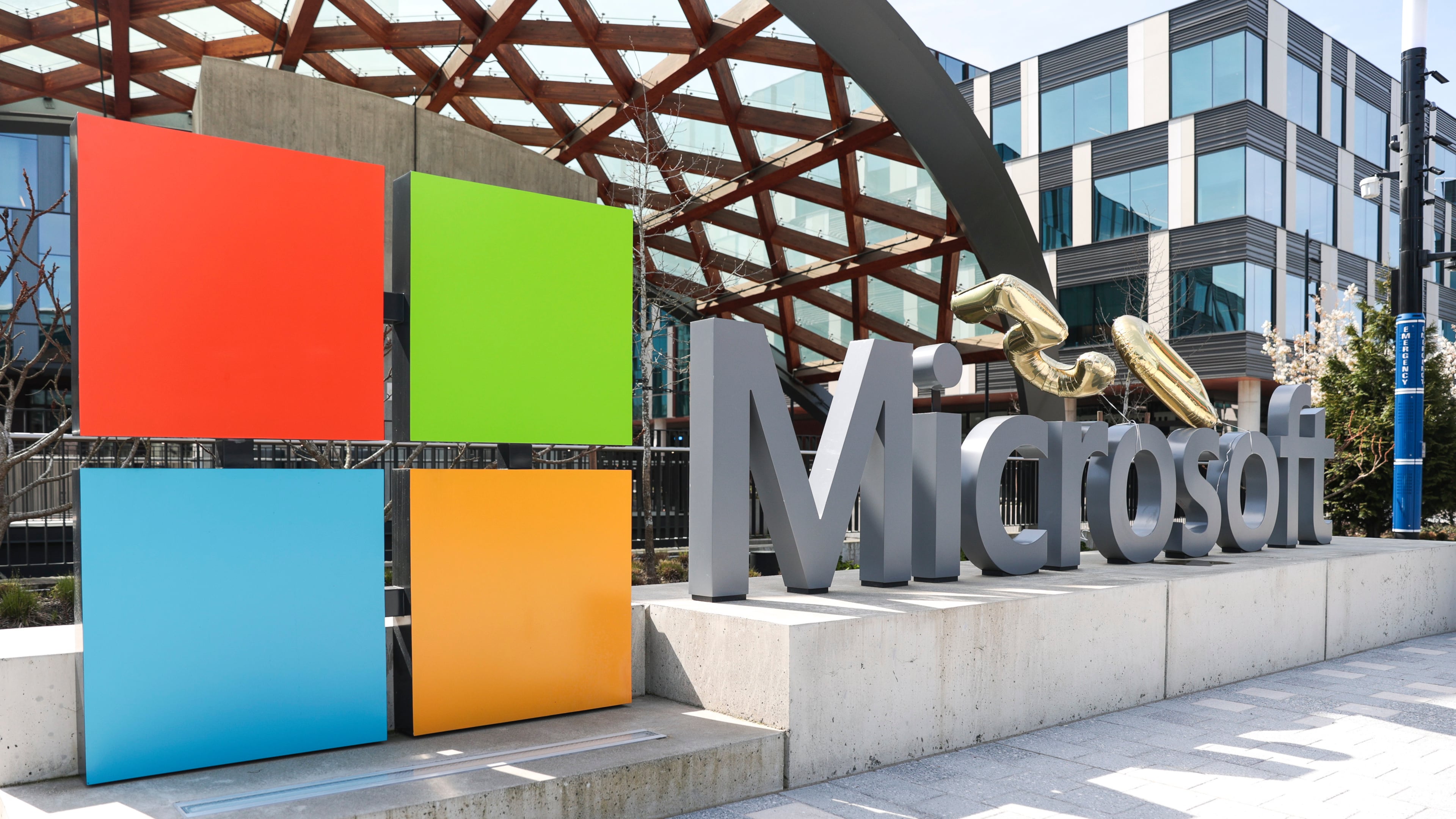 FILE - A Microsoft sign and logo are displayed at the company's headquarters April 4, 2025, in Redmond, Wash. (AP Photo/Jason Redmond, File)