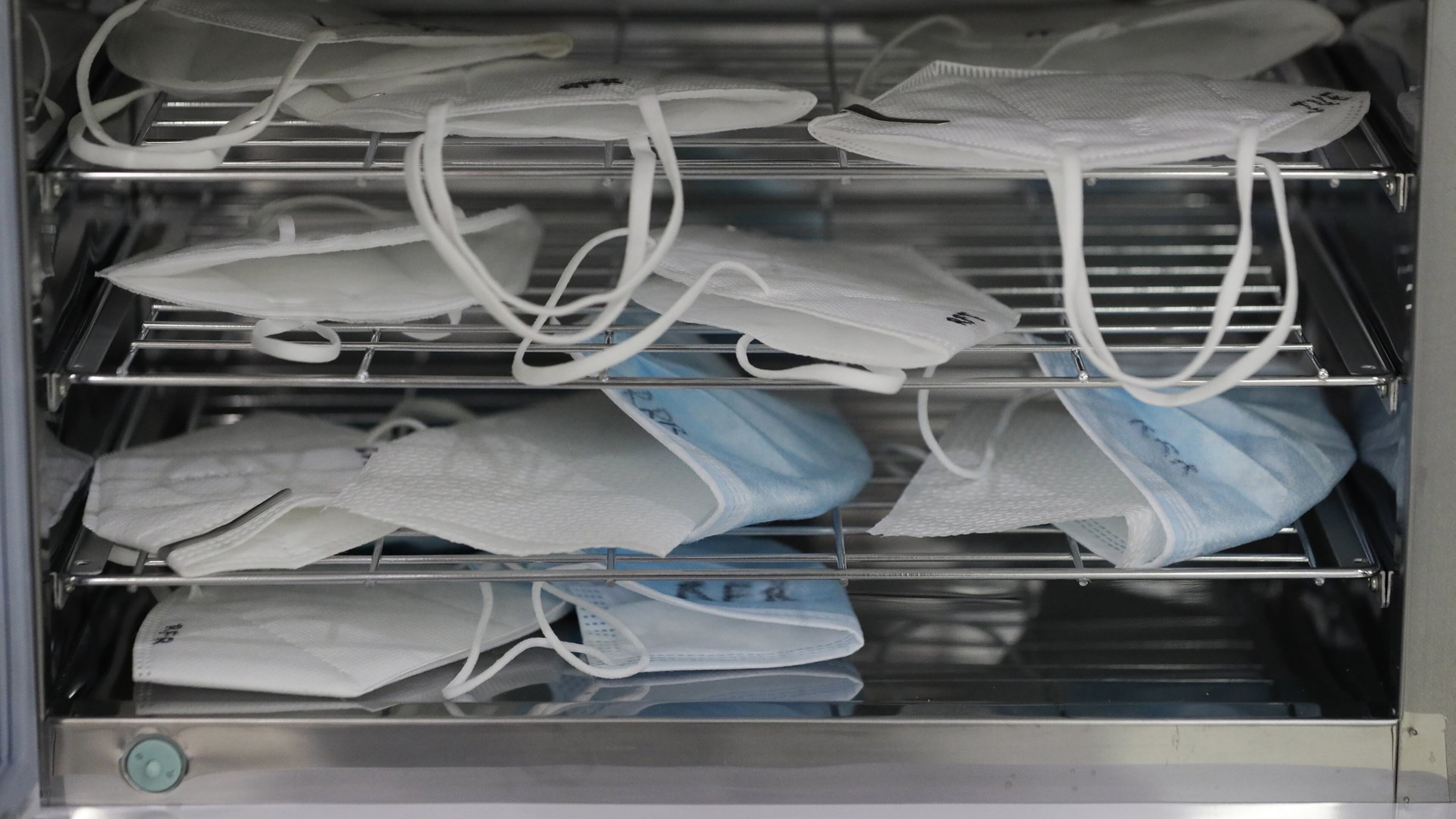 Used face masks are sanitized inside a UV sterilizer so they can be worn again by dentists to prevent the spread of COVID-19 at a clinic in Manila, Philippines on Monday, July 6, 2020. Mask-wearing is seen as critical to flattening the curve of coronavirus infections. (AP Photo/Aaron Favila)