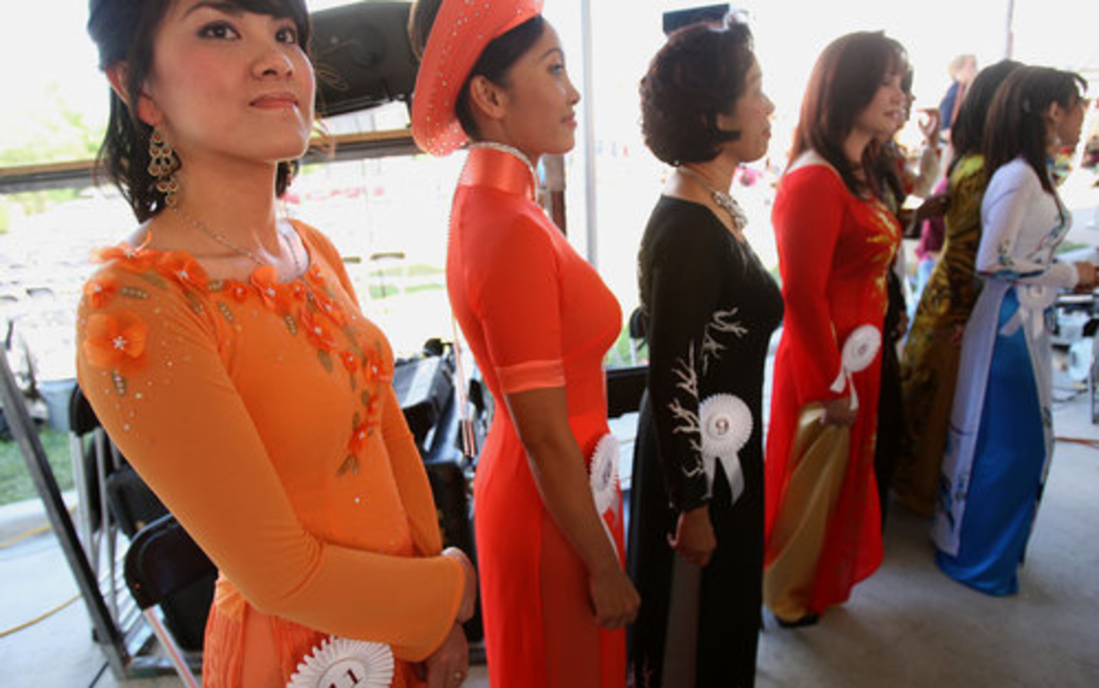 At age 30, Uyen Thao Dan Nguyen, left, is the youngest contestant to compete in the first round of the traditional dress contest during The Holy Martyrs of Vietnam Catholic Church's 2nd Annual Fall Festival in Norcross Sunday, September 5, 2010. A total of 11 contestants take part in the Mrs. contest, each with their own individually fitted style that fits tightly around the upper torso.