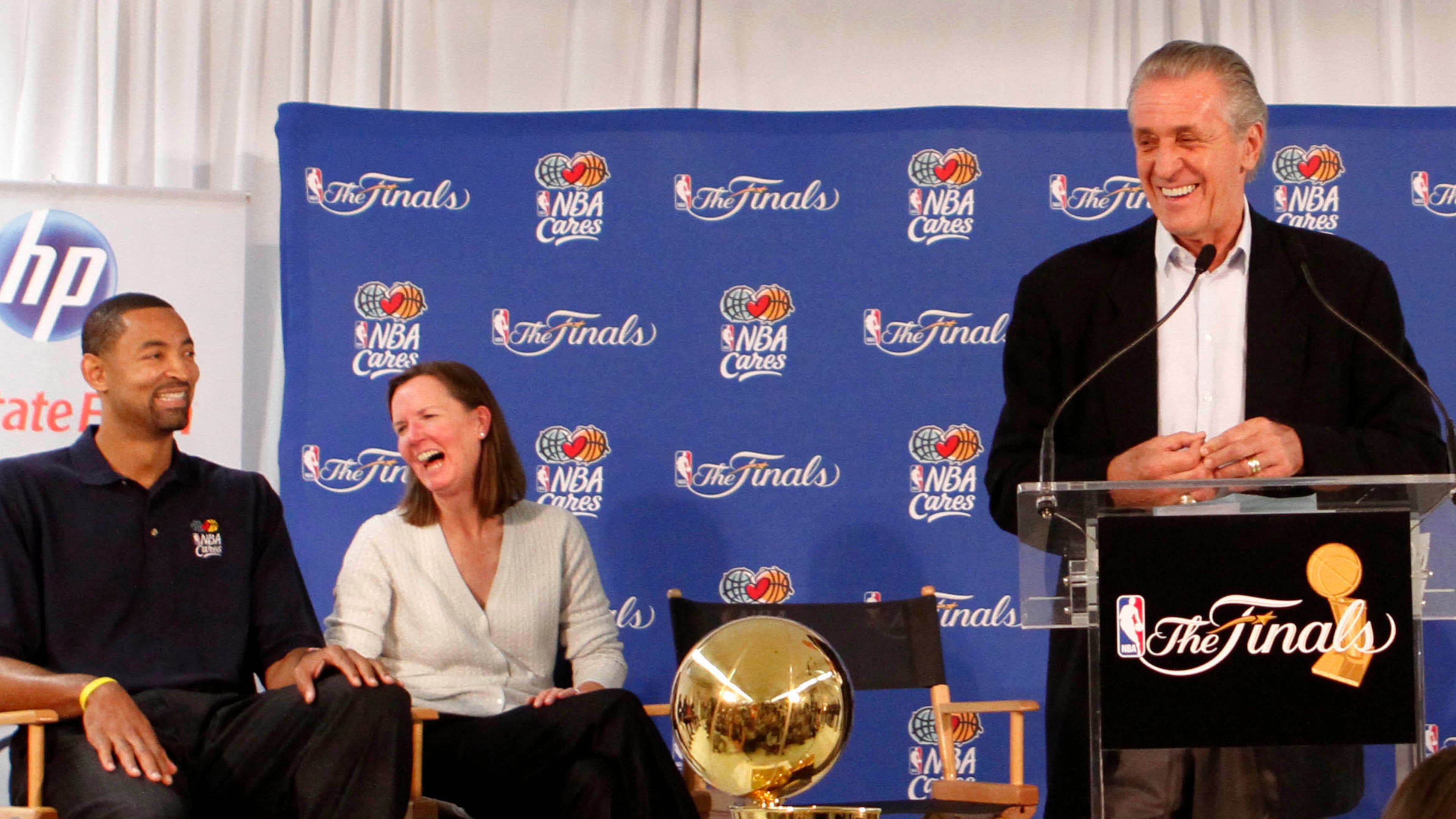 Miami Heat President Pat Riley,center, laughs as he talks to students at Paul Laurence Dunbar Elementary School, as from left Juwan Howard and Kathy Behrens listen, Wednesday, June 1, 2011, in Miami. (AP Photo/Alan Diaz, File)