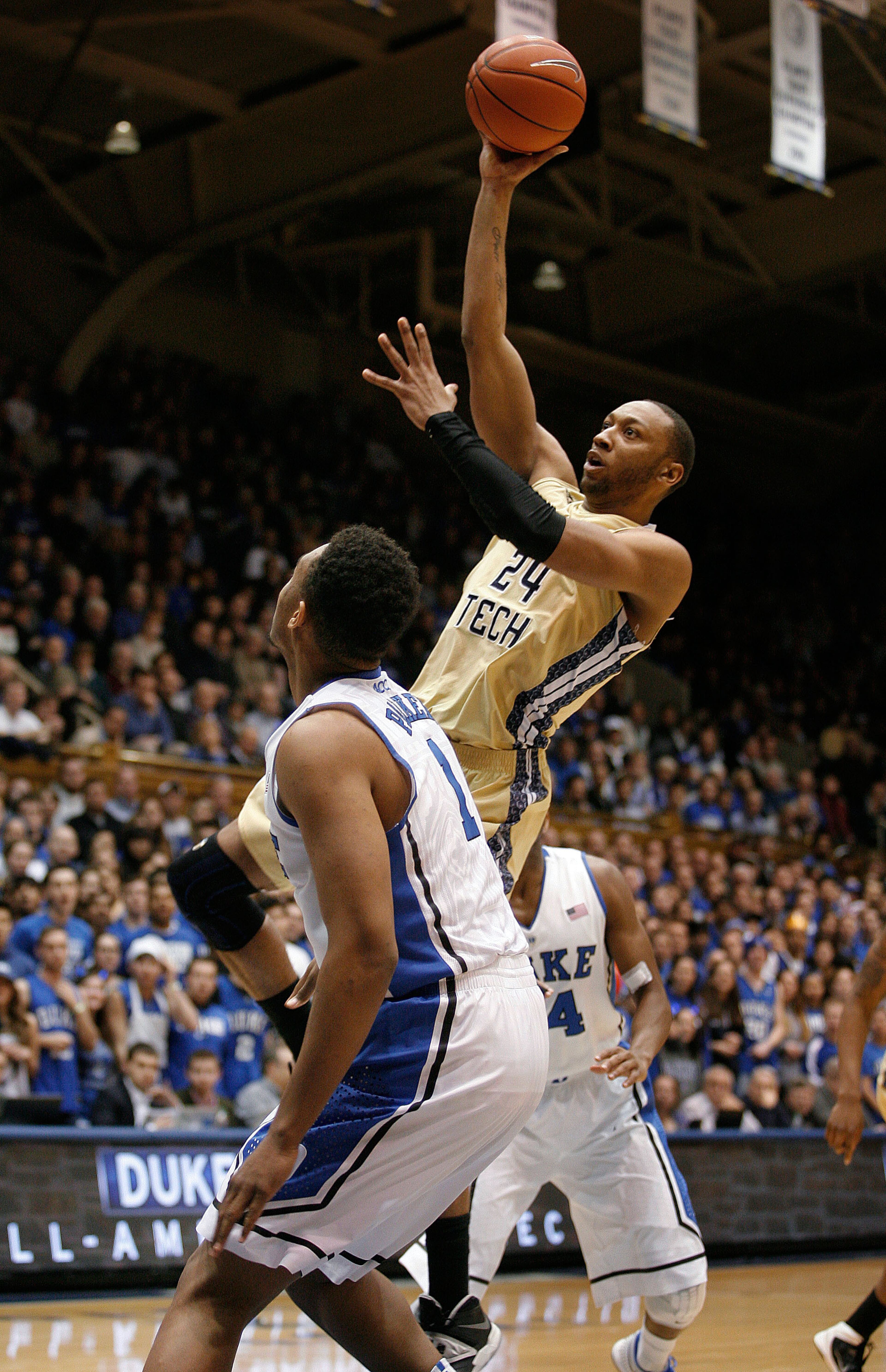 Georgia Tech Yellow Jackets forward Kammeon Holsey (24) shoots over Duke Blue Devils forward Jabari Parker (1) at Cameron Indoor Stadium.