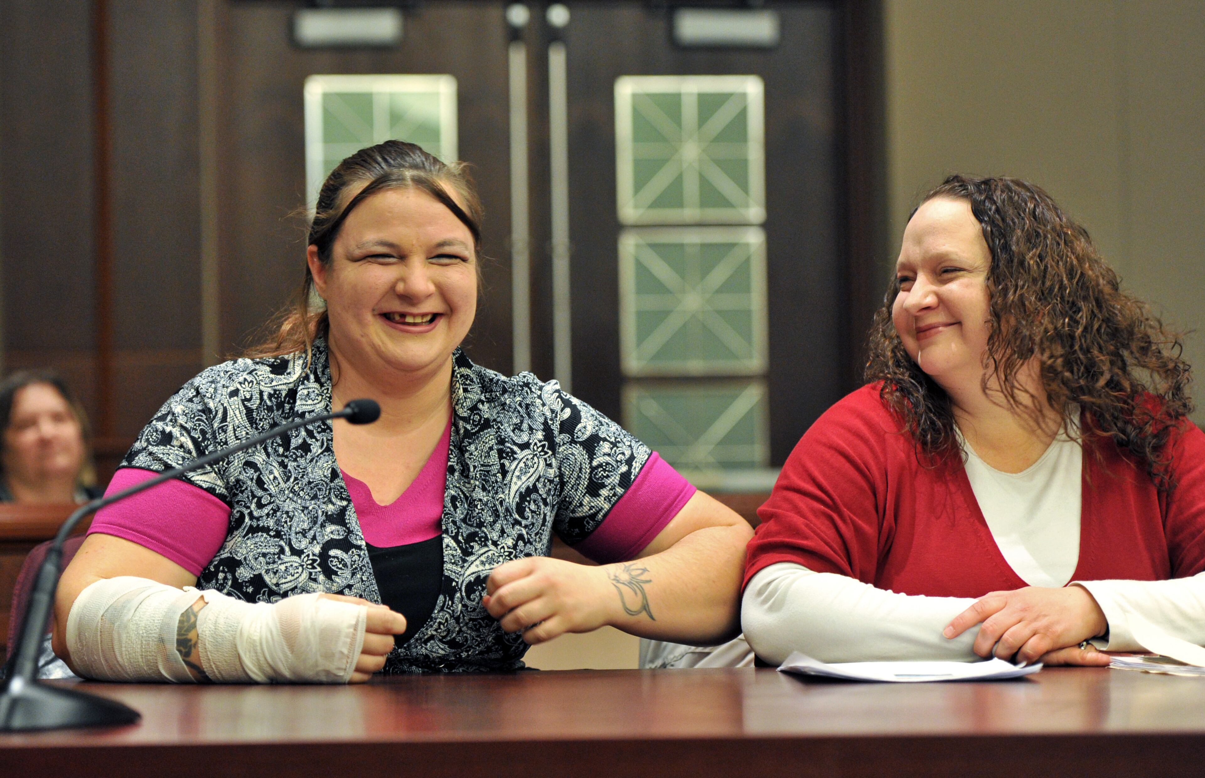 Toshia Brown (left) shares a laugh with other program participant Julie Jones during their session at Douglas County Juvenile Court in Douglasville. Despite the many challenges Toshia has had to overcome, she is quick to smile these days. "I'm meant to be a sober person," she says. HYOSUB SHIN / HSHIN@AJC.COM