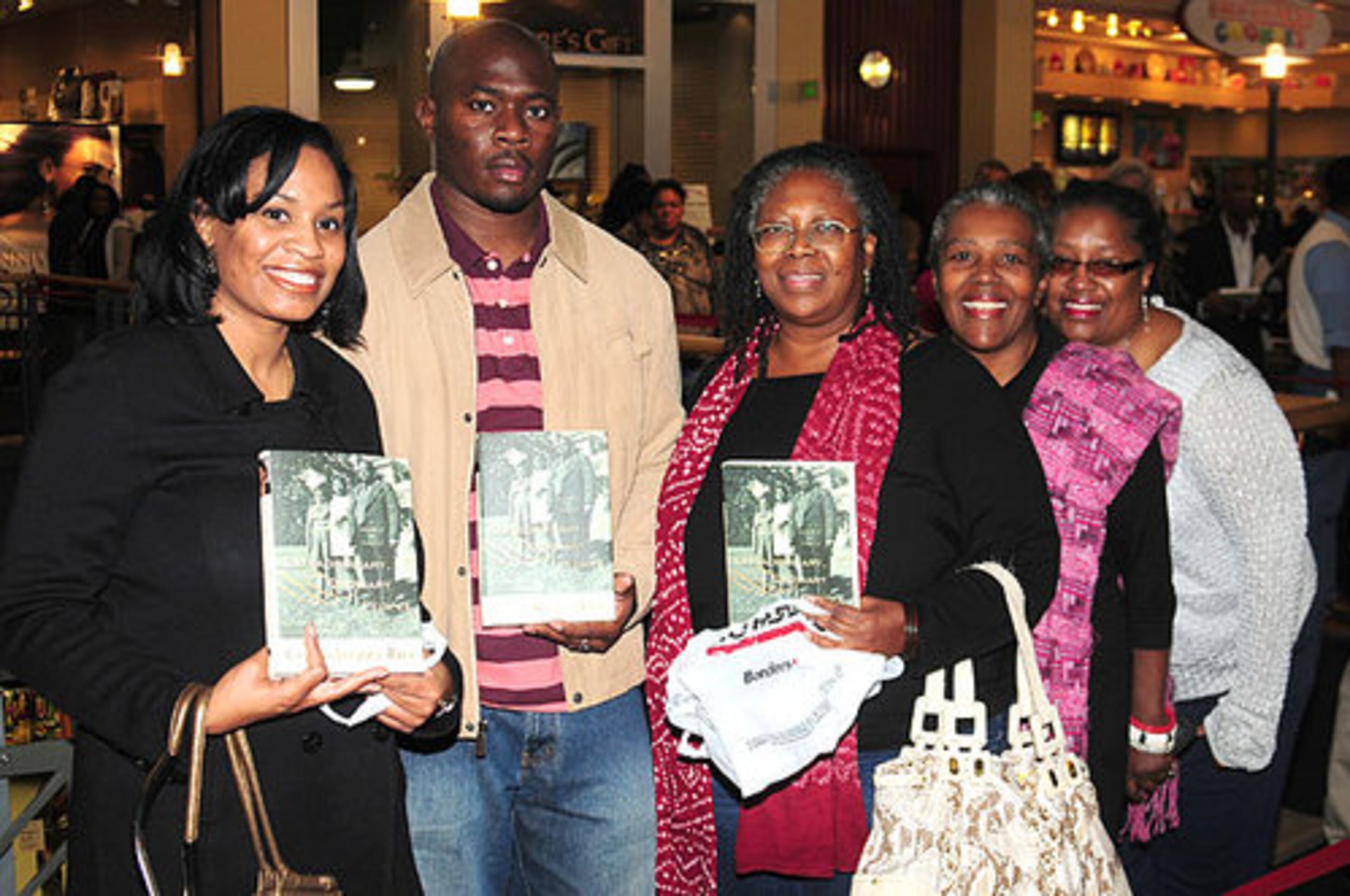 Aileen Harris, Mack Rosemond, Linda Rodriguez, Henritte Turnquest, and Sharon Schneider wait in line to have their books signed by former Secretary of State, Condoleeza Rice.
