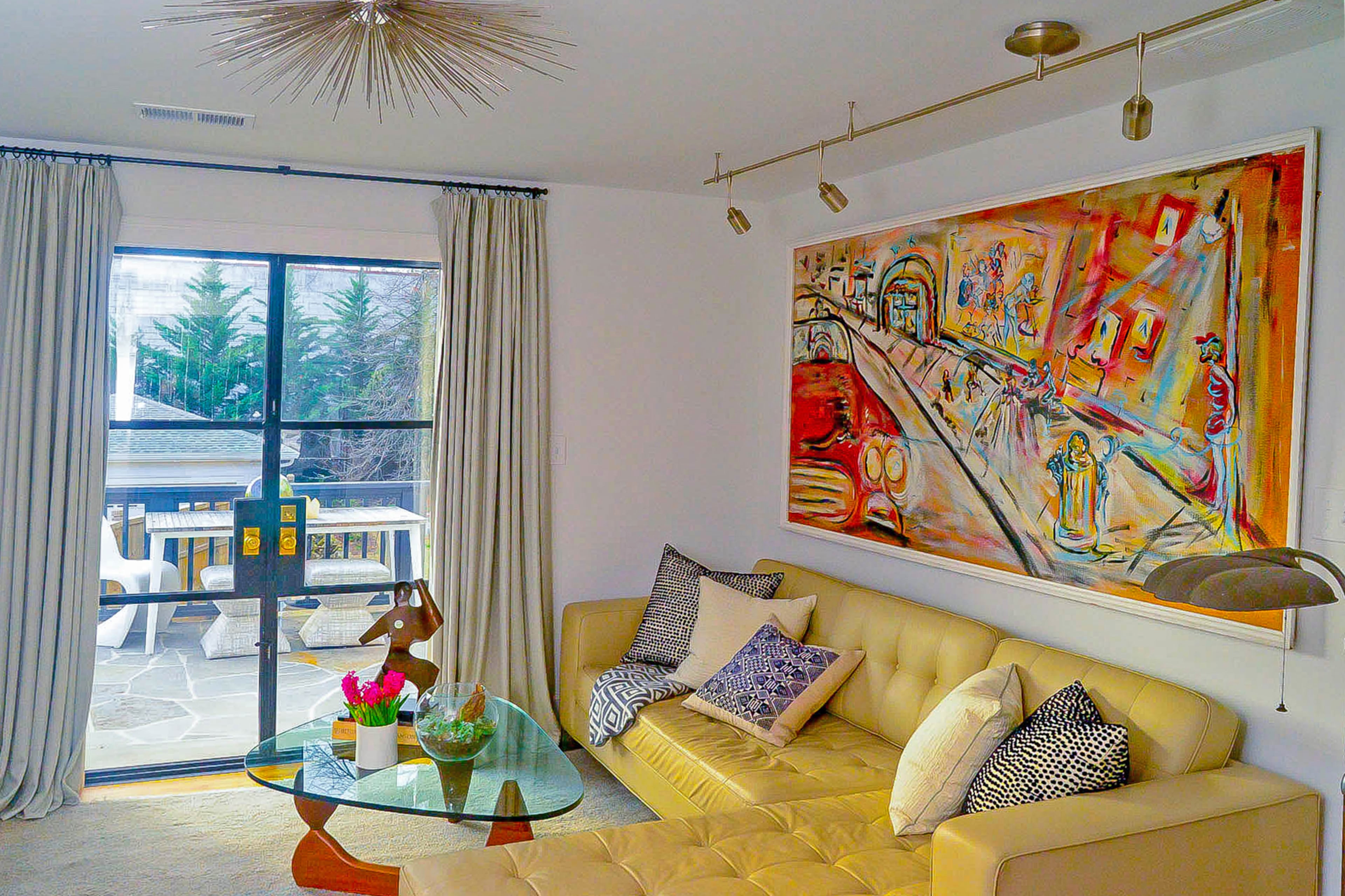 The third bedroom now serves as a master sitting area. The leather sectional is a custom piece by TecnoSedia; the Roxanne flush mount chandelier is by Arteriors. Text by Lori Johnston/Fast Copy News Service.(Christopher Oquendo/www.ophotography.com)