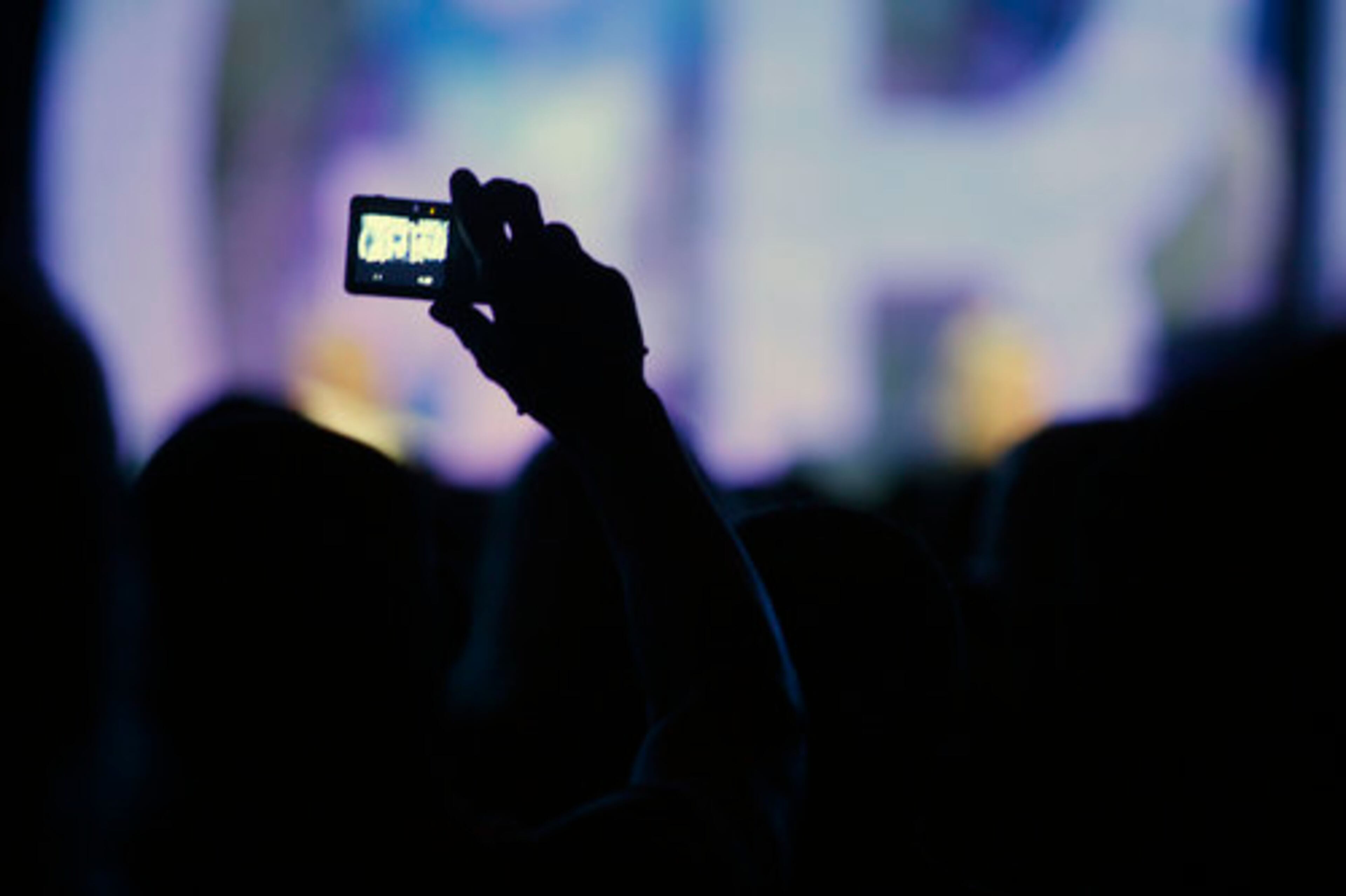 SPECTATORS TAKE photographs during the session.