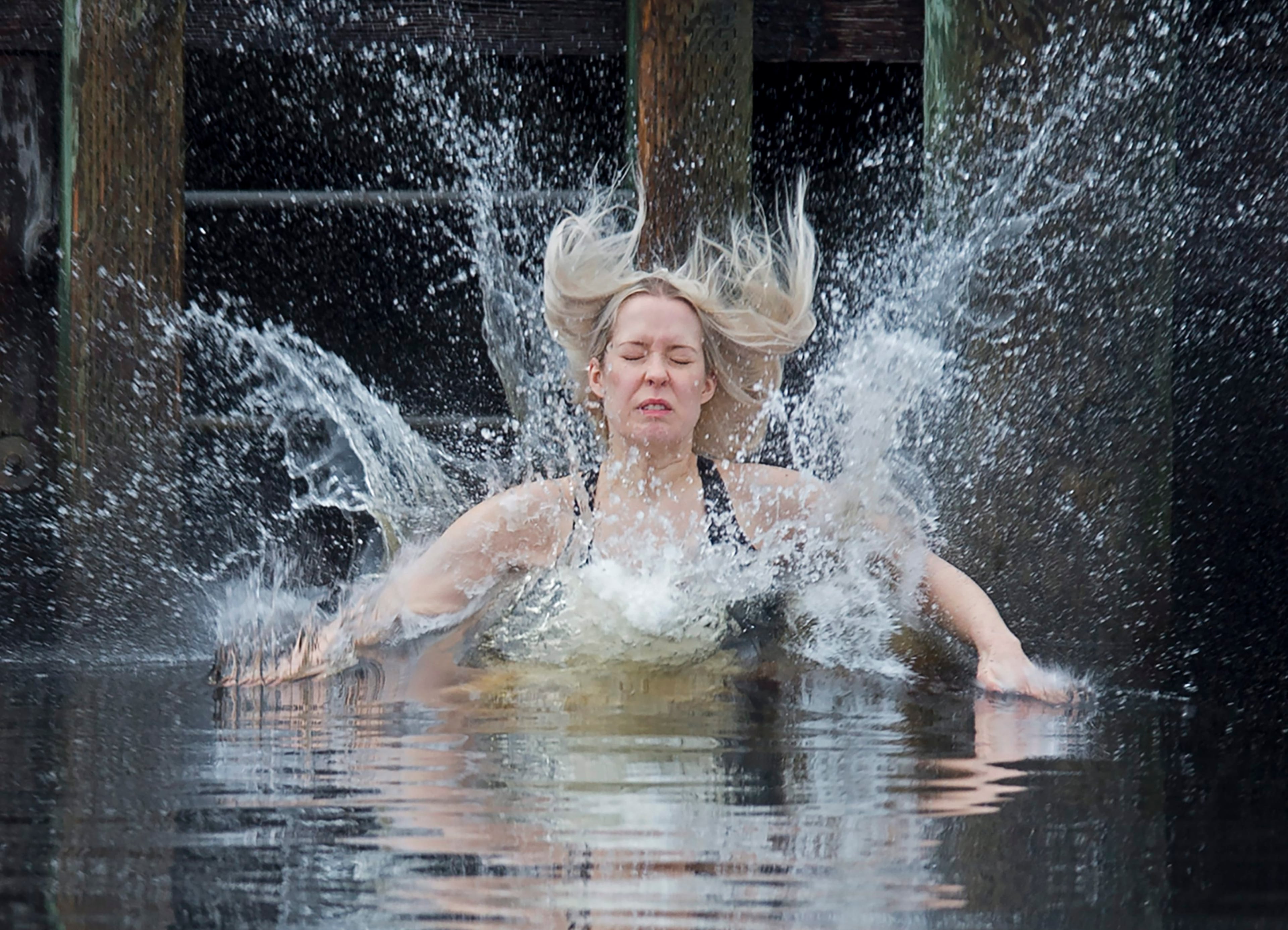 A reveller jumps into the frigid North Atlantic in Herring Cove in the annual polar bear swim in Halifax, Canada, Friday, Jan. 1, 2016. (Andrew Vaughan/The Canadian Press via AP)