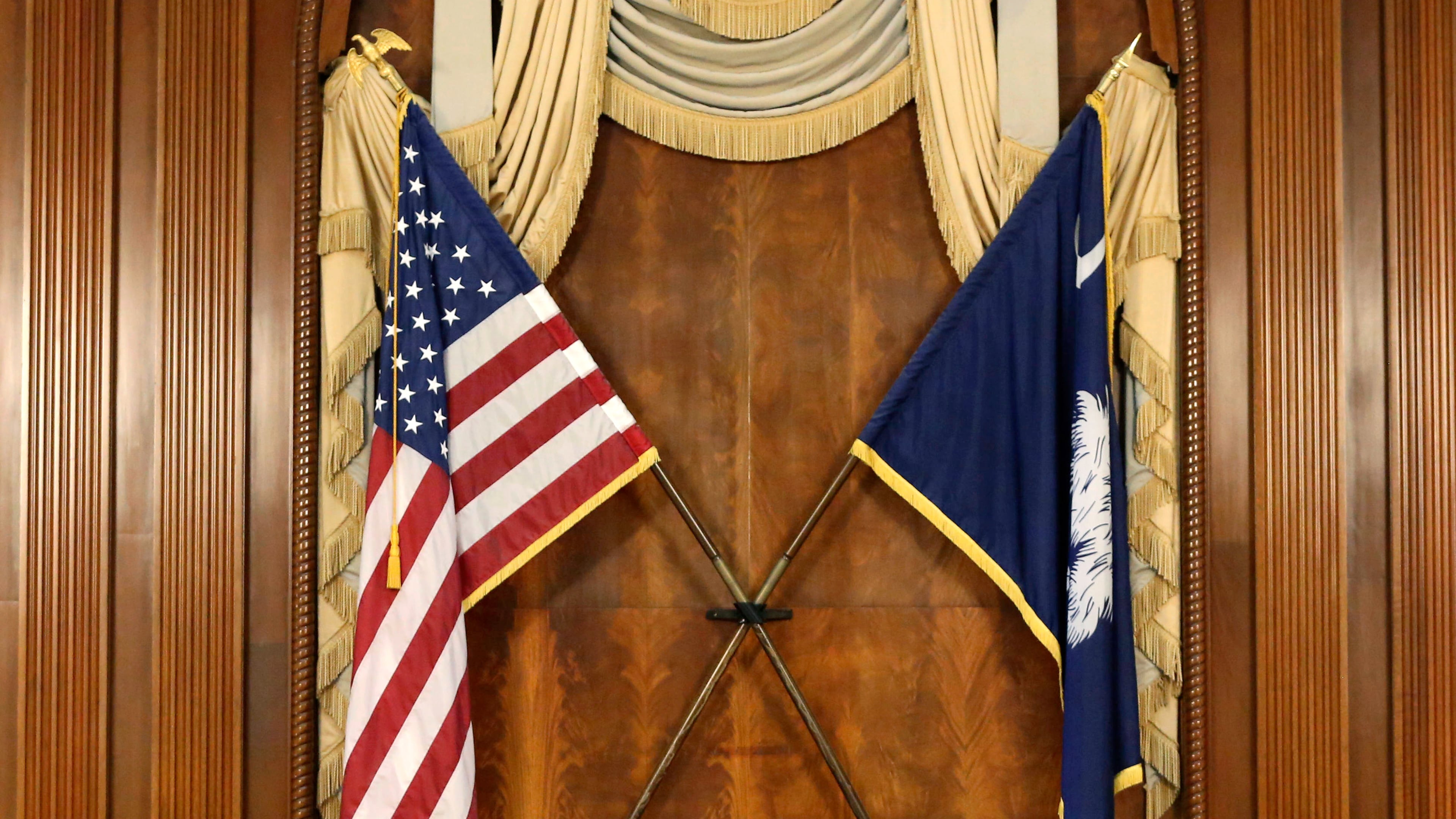FILE - The U.S. and South Carolina flags hang in the South Carolina statehouse, March 16, 2021, in Columbia, S.C . (AP Photo/Jeffrey Collins, File)
