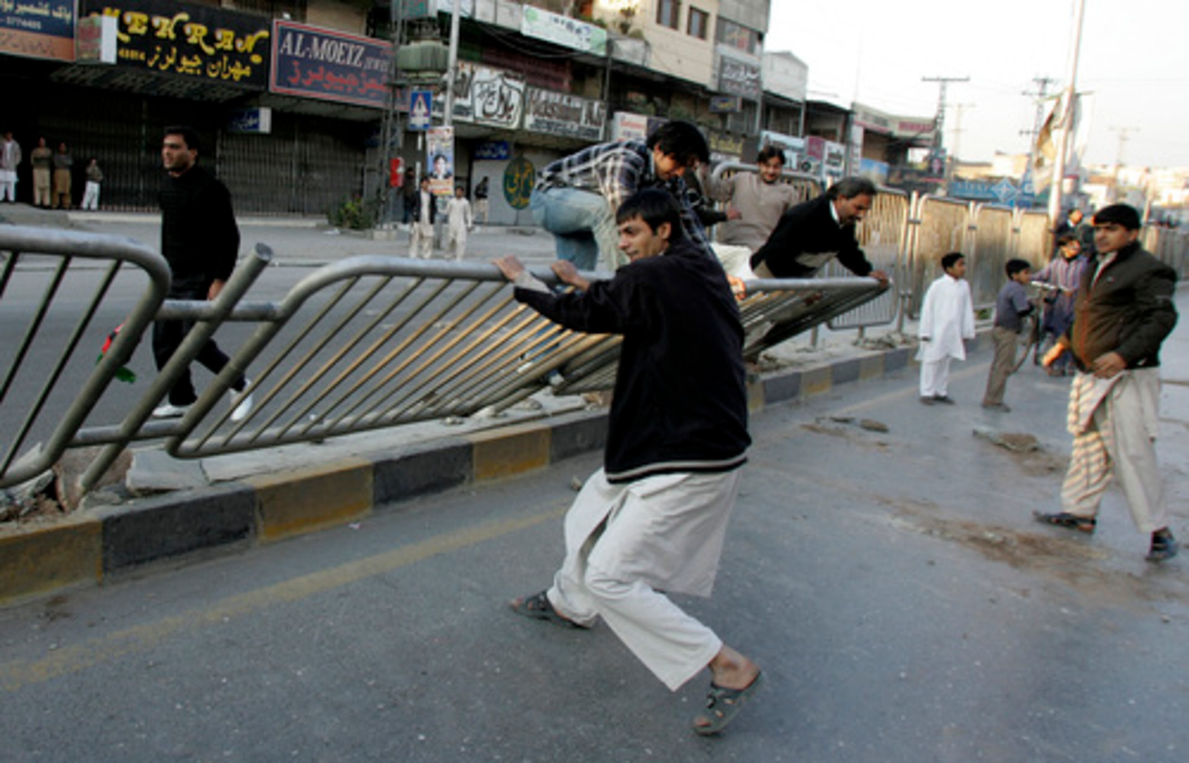 Angry supporters of slain opposition leader Benazir Bhutto damage a fence during a rally in Rawalpindi, Pakistan.