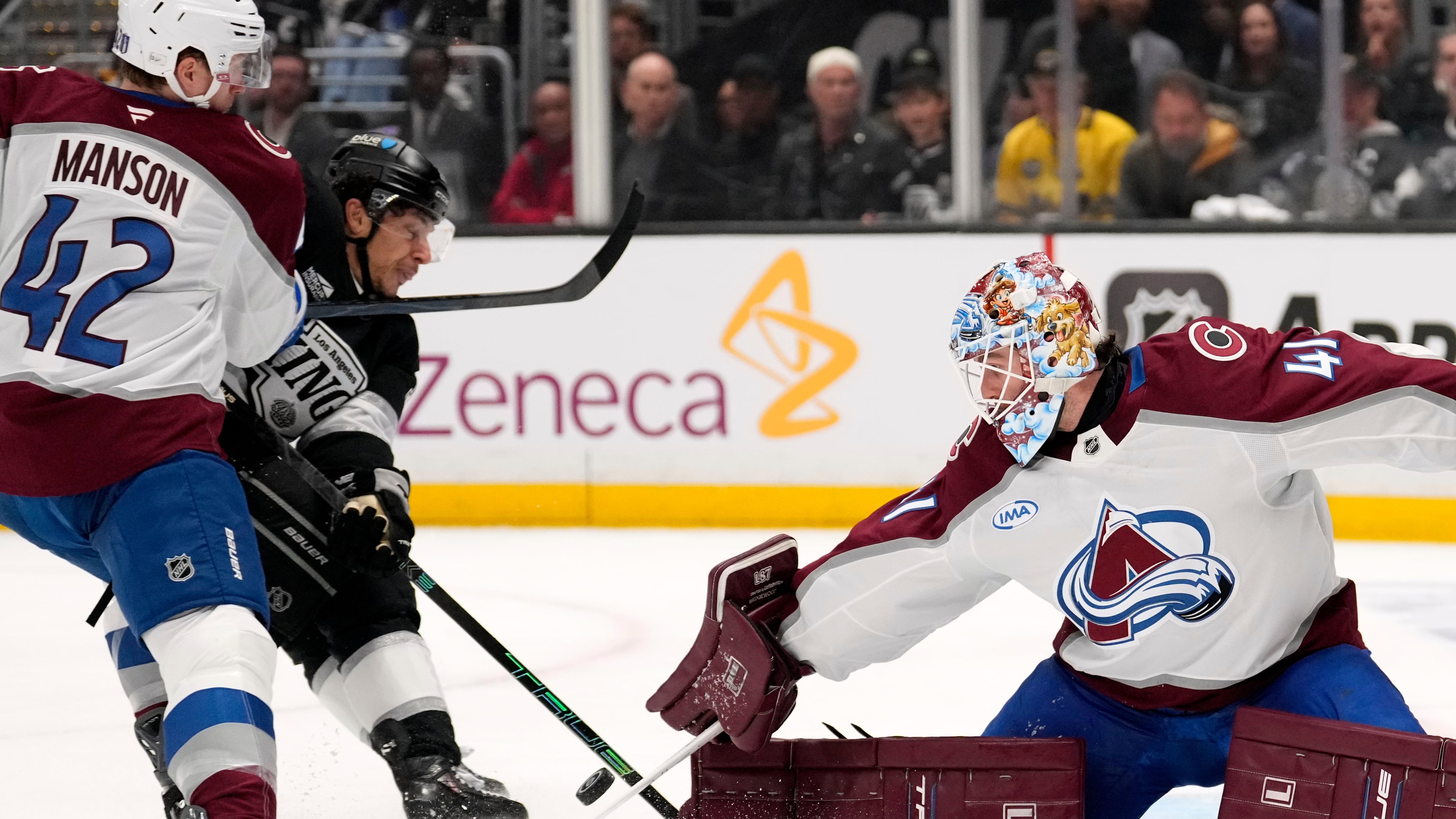 Los Angeles Kings left wing Trevor Moore, center, scores on goaltender Scott Wedgewood, right, as defenseman Josh Manson defends during the second period of Game 3 in the first round of the NHL hockey Stanley Cup playoffs Thursday, April 23, 2026, in Los Angeles. (AP Photo/Mark J. Terrill)
