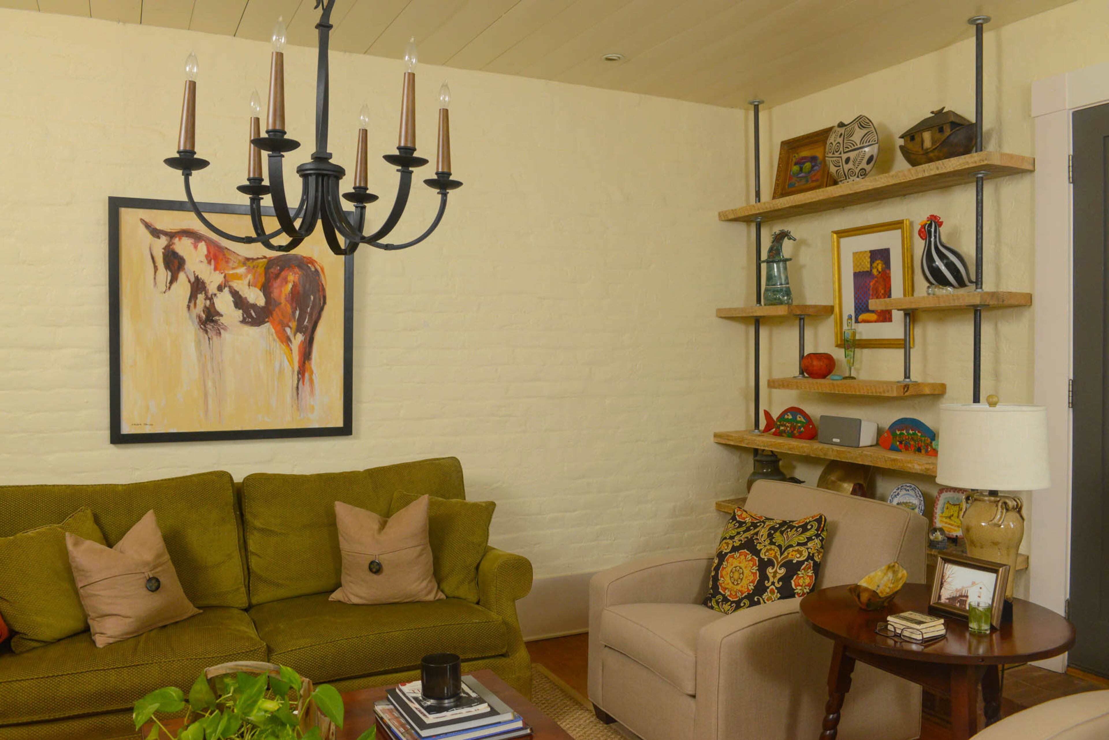 Shelves made from reclaimed barn wood and pipes, from The Home Depot, house decorative knick-knacks, from a blown-glass rooster to a wooden ark.