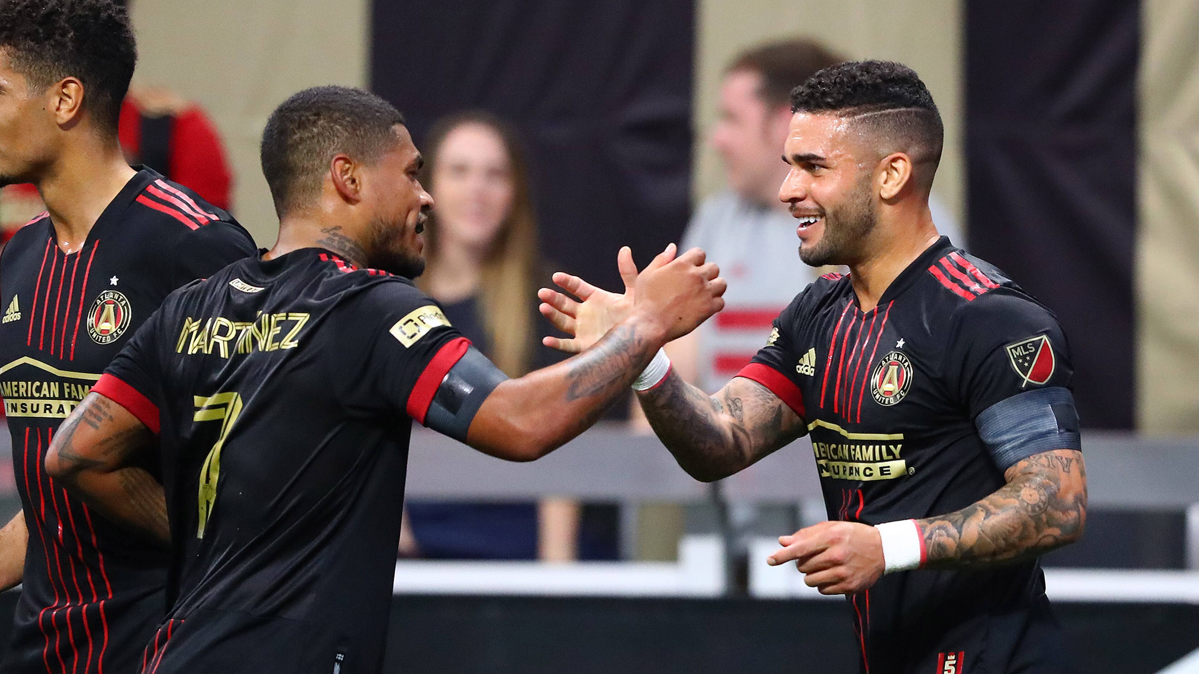 022722 : Atlanta United attacker Dom Dwyer (right) gets five from fellow attacher Josef Martinez after scoring a goal for a 2-0 lead over Sporting KC in a MLS soccer match on Sunday, Feb. 27, 2022, in Atlanta. “Curtis Compton / Curtis.Compton@ajc.com”`