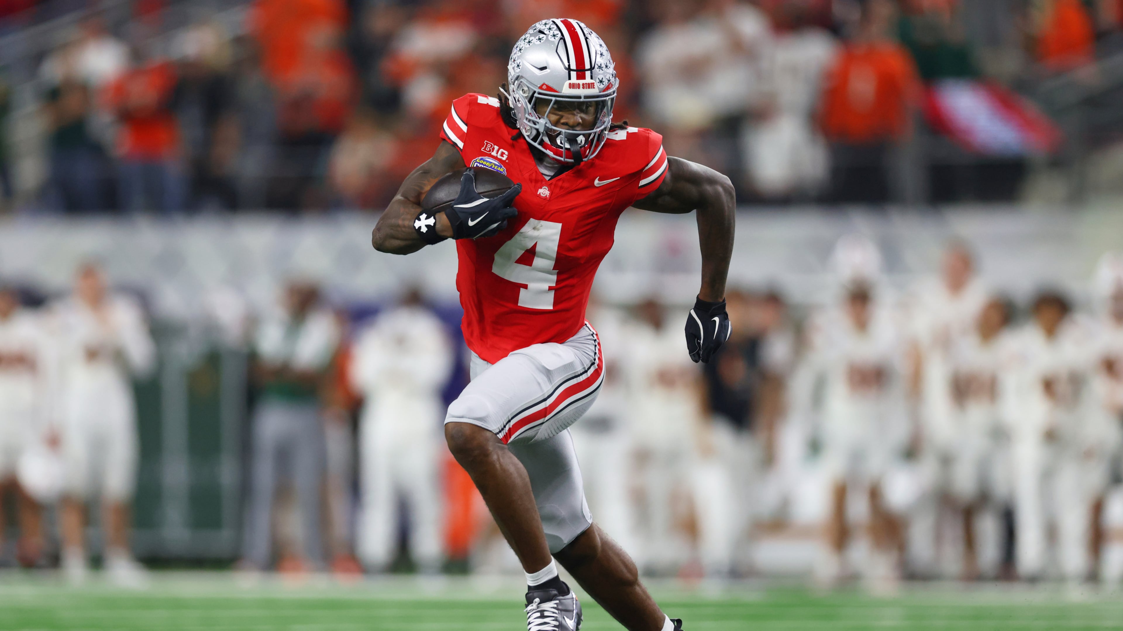 FILE - Ohio State wide receiver Jeremiah Smith runs the ball against Miami during the second half of the Cotton Bowl College Football Playoff quarterfinal game, Dec. 31, 2025, in Arlington, Texas. (AP Photo/Gareth Patterson, File)