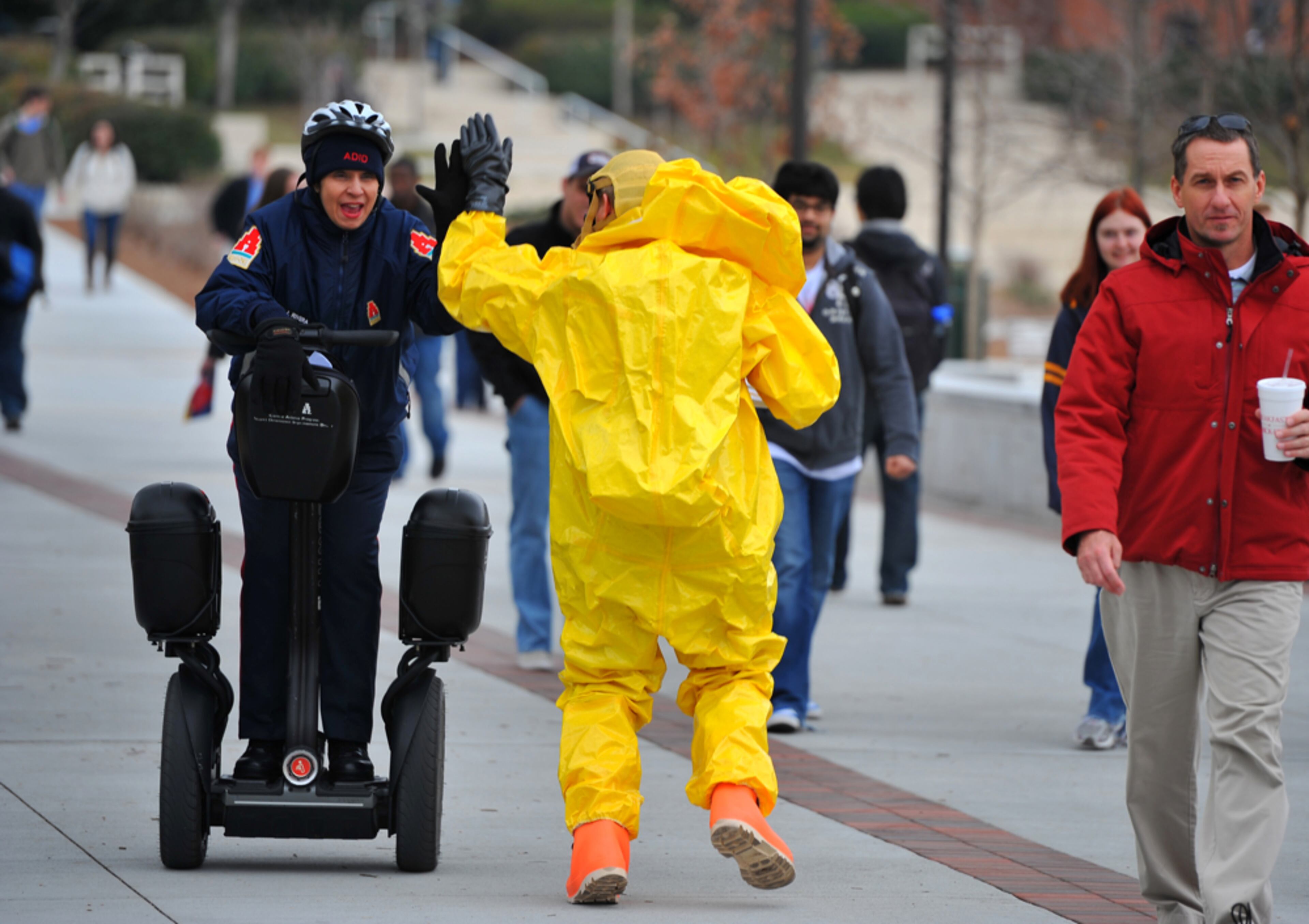 021012 Atlanta: Perry Craine, wearing a chemical resistant suit gets a high five from Atlanta Ambassador Justine Rivera during Georgia Tech's third annual campus safety day Friday February 10, 2012. Campus police showcased their latest equipment and promoted their new Smart911 Center. Brant Sanderlin bsanderlin@ajc.com