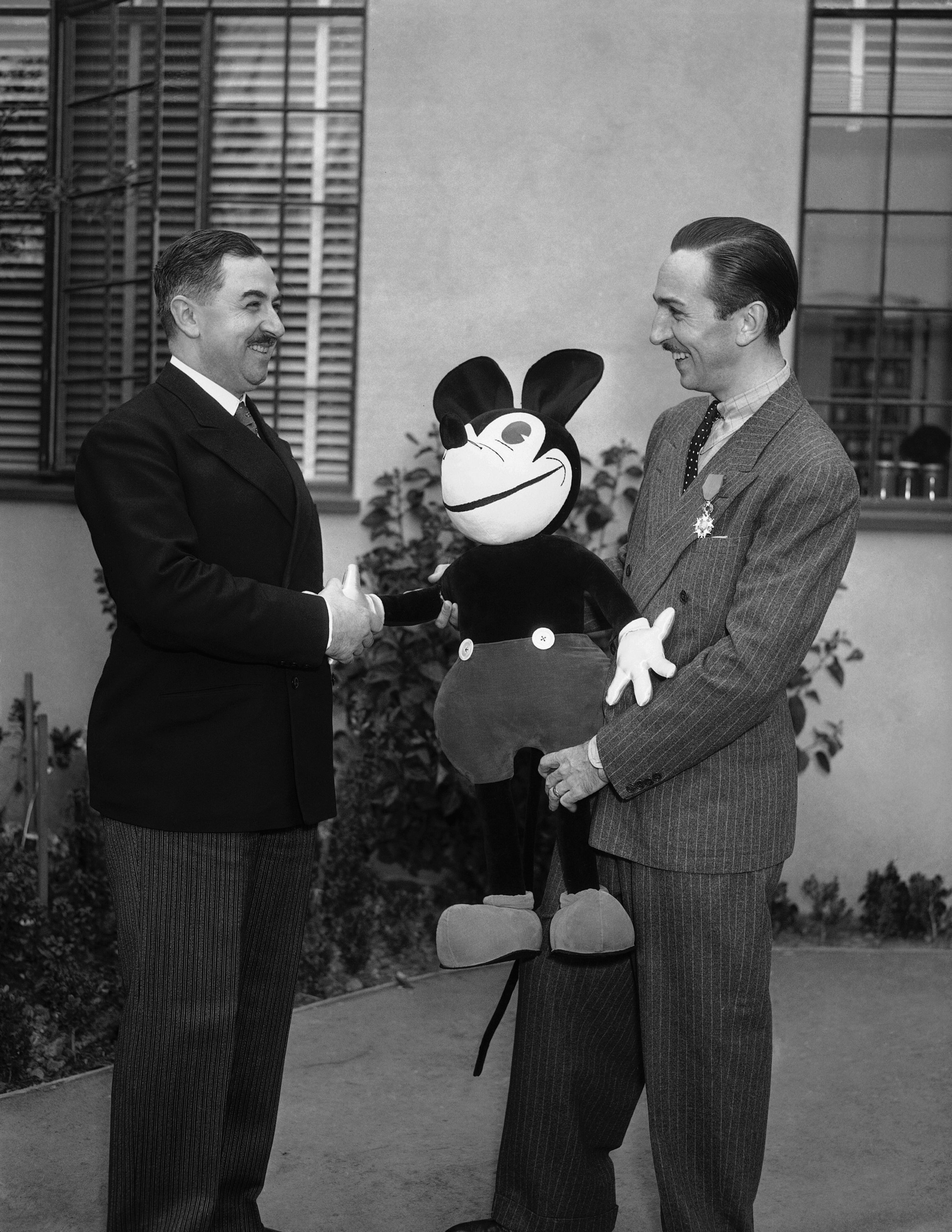 The Legion of Honor was conferred upon Walt Disney, right, creator of Mickey Mouse, in a ceremony in Hollywood, Jan. 8, 1936. Mons. J.J. Viala, French consul, left, pinned the decoration upon Disney in recognition, it was said, for his contribution to the screen. (AP Photo)