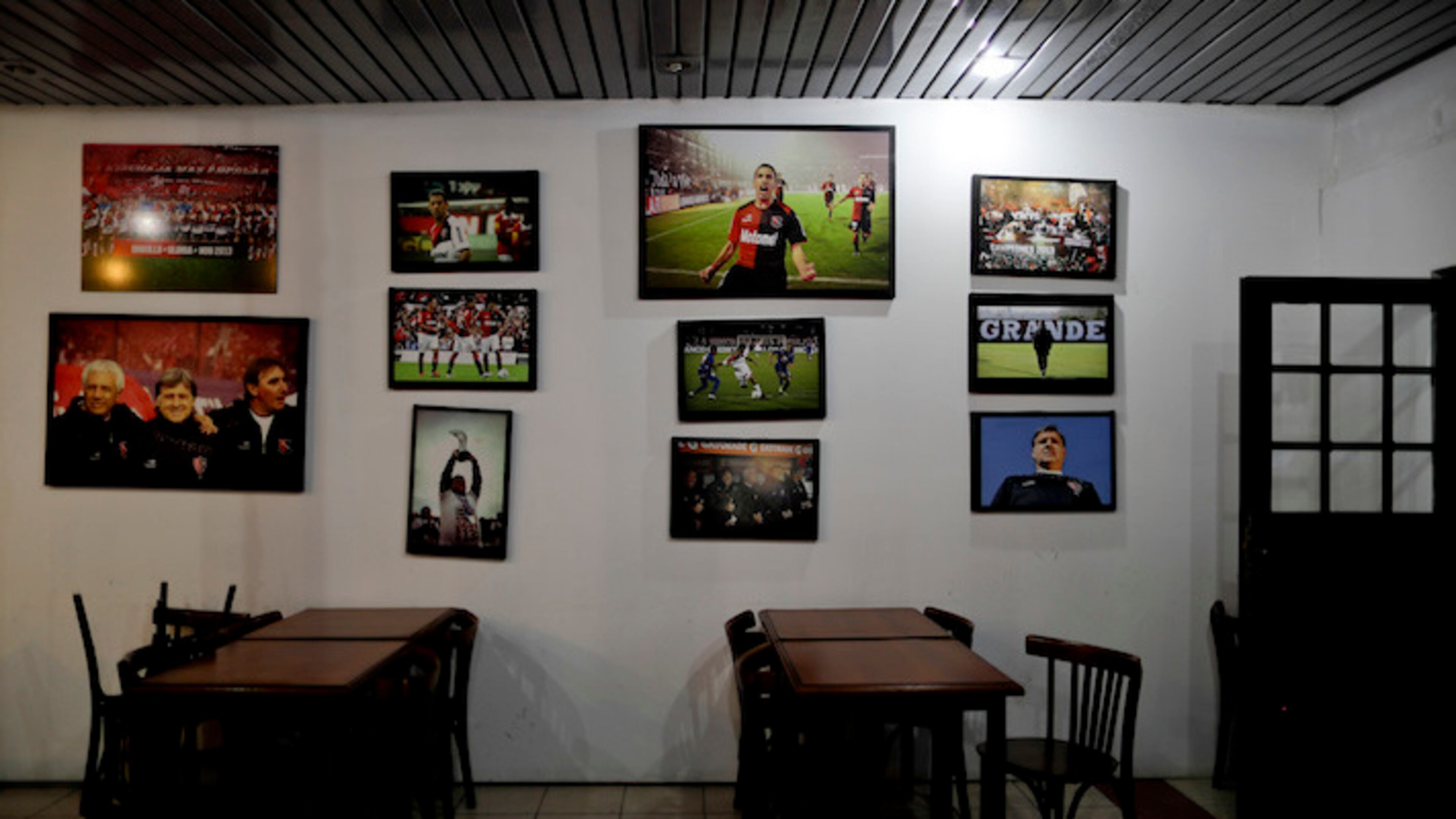 In this April 17, 2018 photo, photos of great soccer moments decorate the cafeteria inside Newell's Old Boys youth training center in Rosario, Argentina, the hometown of Lionel Messi. Photos of former coaches and players lifting trophies decorate the cafeteria's walls, but there's not a single image of Messi, the five-time FIFA world player of the year. (AP Photo/Natacha Pisarenko)