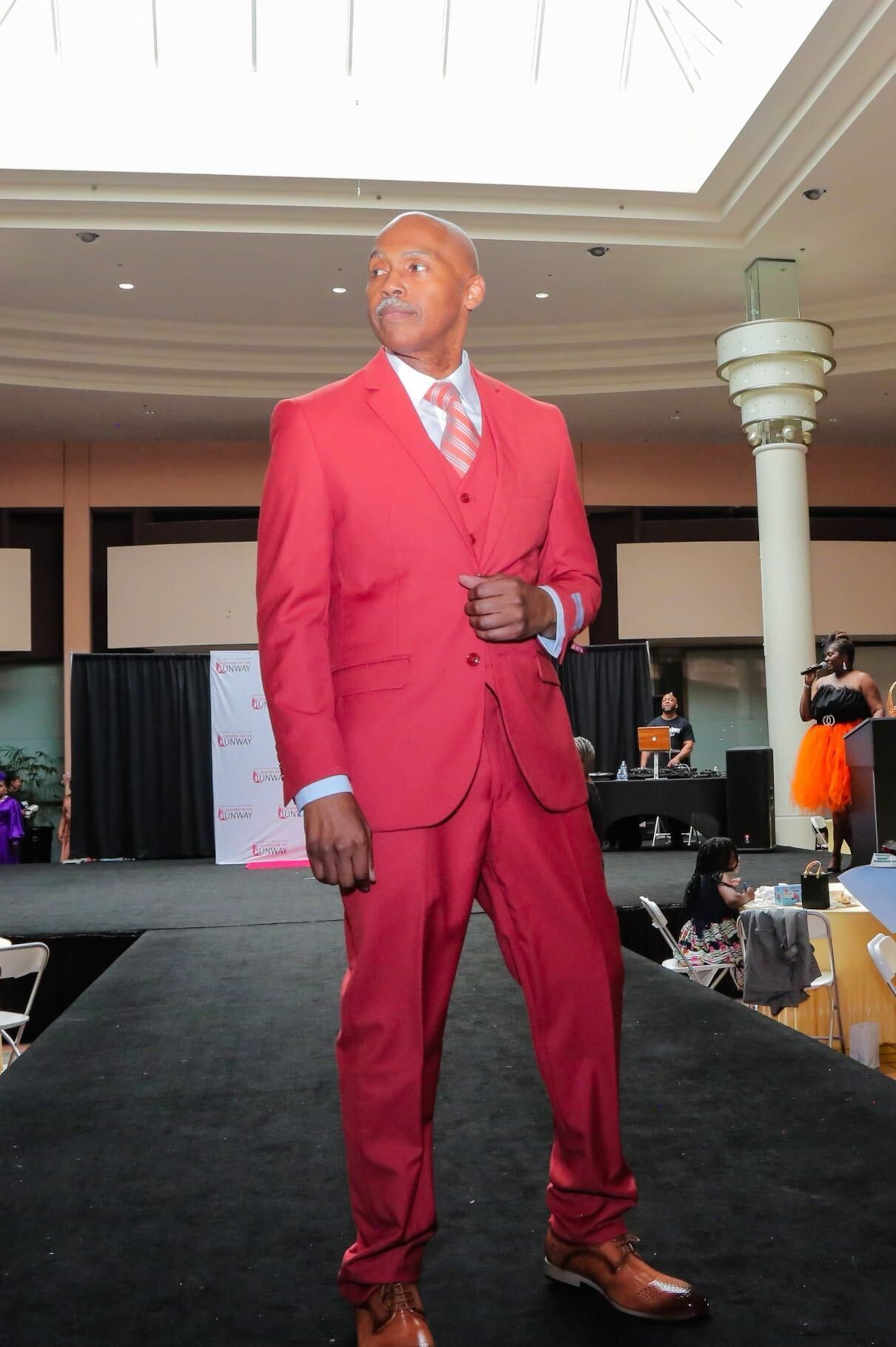 A male model strikes a pose at 'Seniors on the Runway' on May 4, 2024, at Greenbriar Mall.