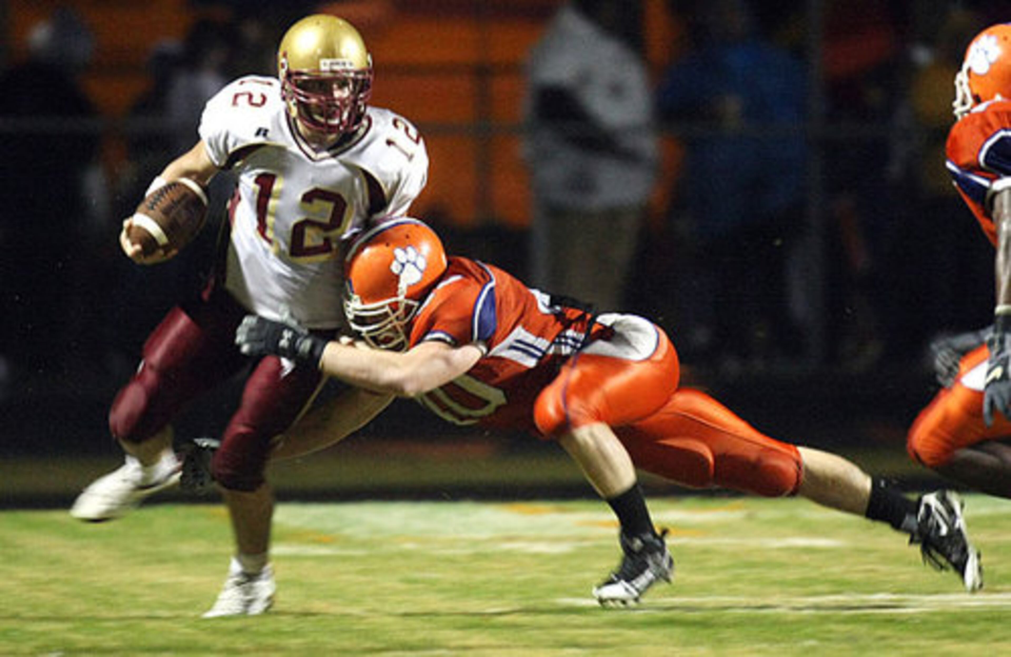 Brookwood quarterback #12 Ben McLane is brought down at the end of a run on a quarterback keeper with a leaping tackle by Parkview linebacker #40 Matt Johnson.