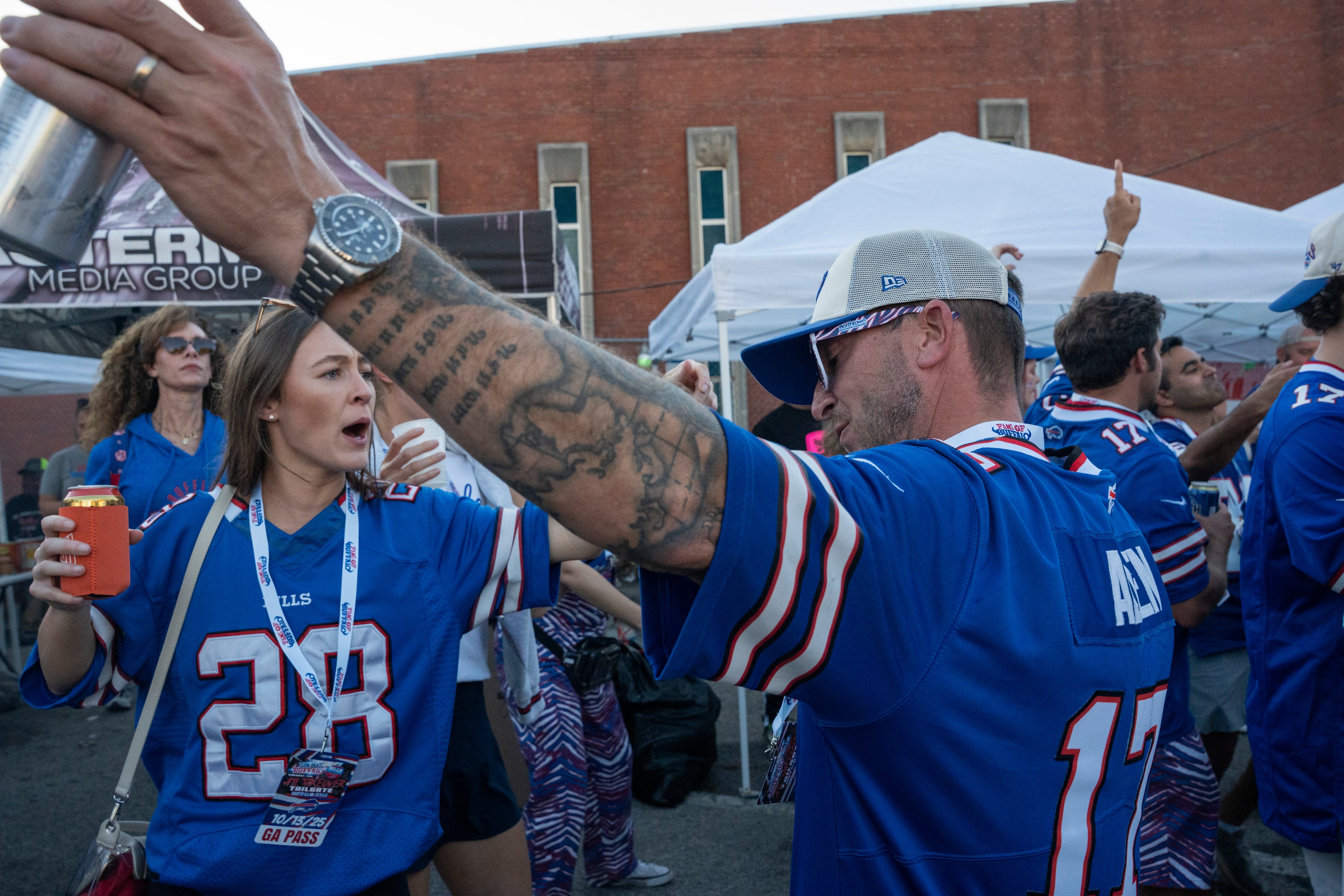 Buffalo Bills fans dance and celebrate at a tailgate near Mercedes-Benz Stadium on Monday, Oct. 13, 2025, in Atlanta, before the Monday Night Football game between the Bills and the Falcons. (Olivia Bowdoin for the AJC)