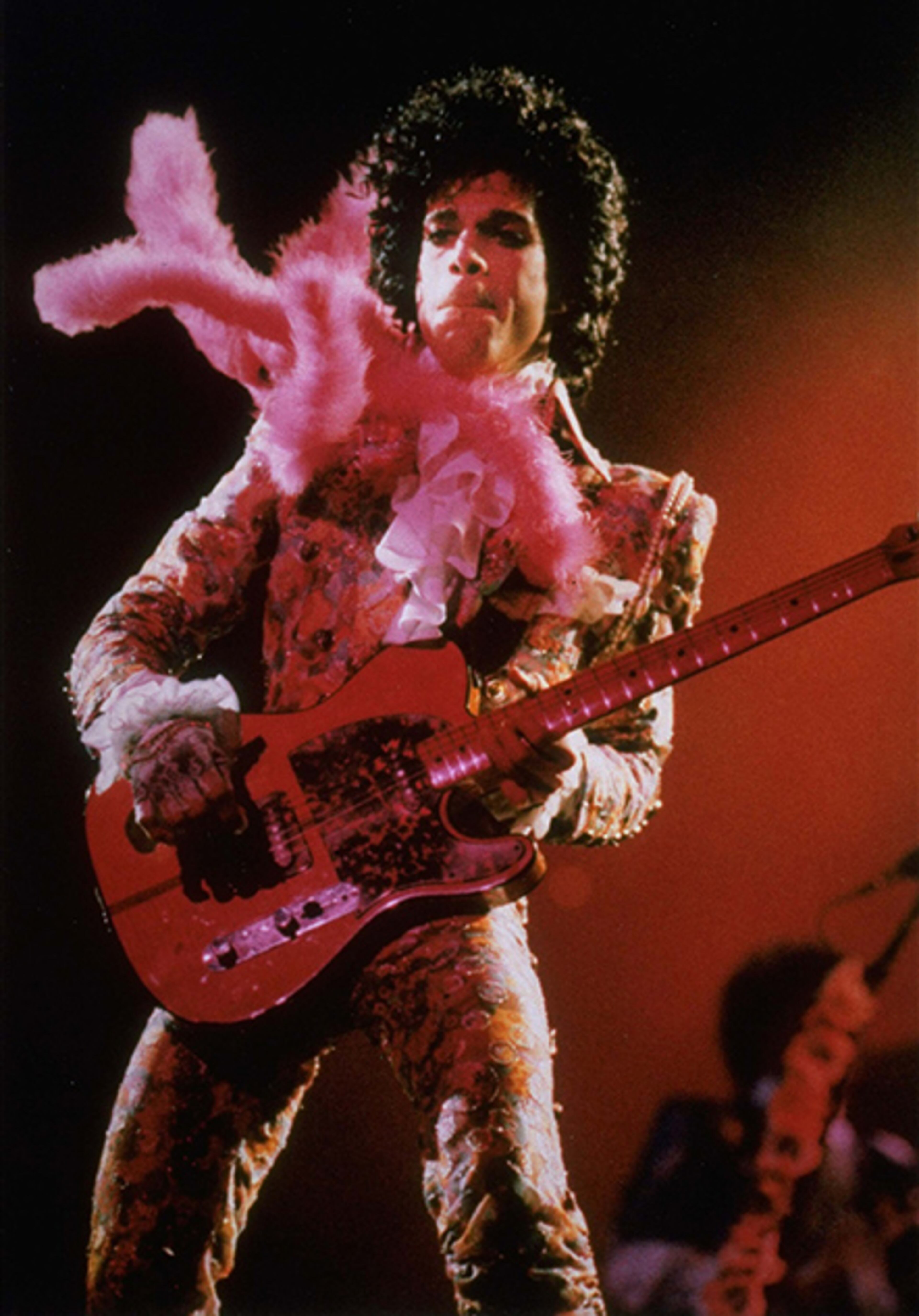 urple Rain star Prince performs in concert at the Summit Thursday night, Jan. 11, 1985 before a sold-out audience, his first of six Houston shows. A purple feather boa blows in the wind from a fan.