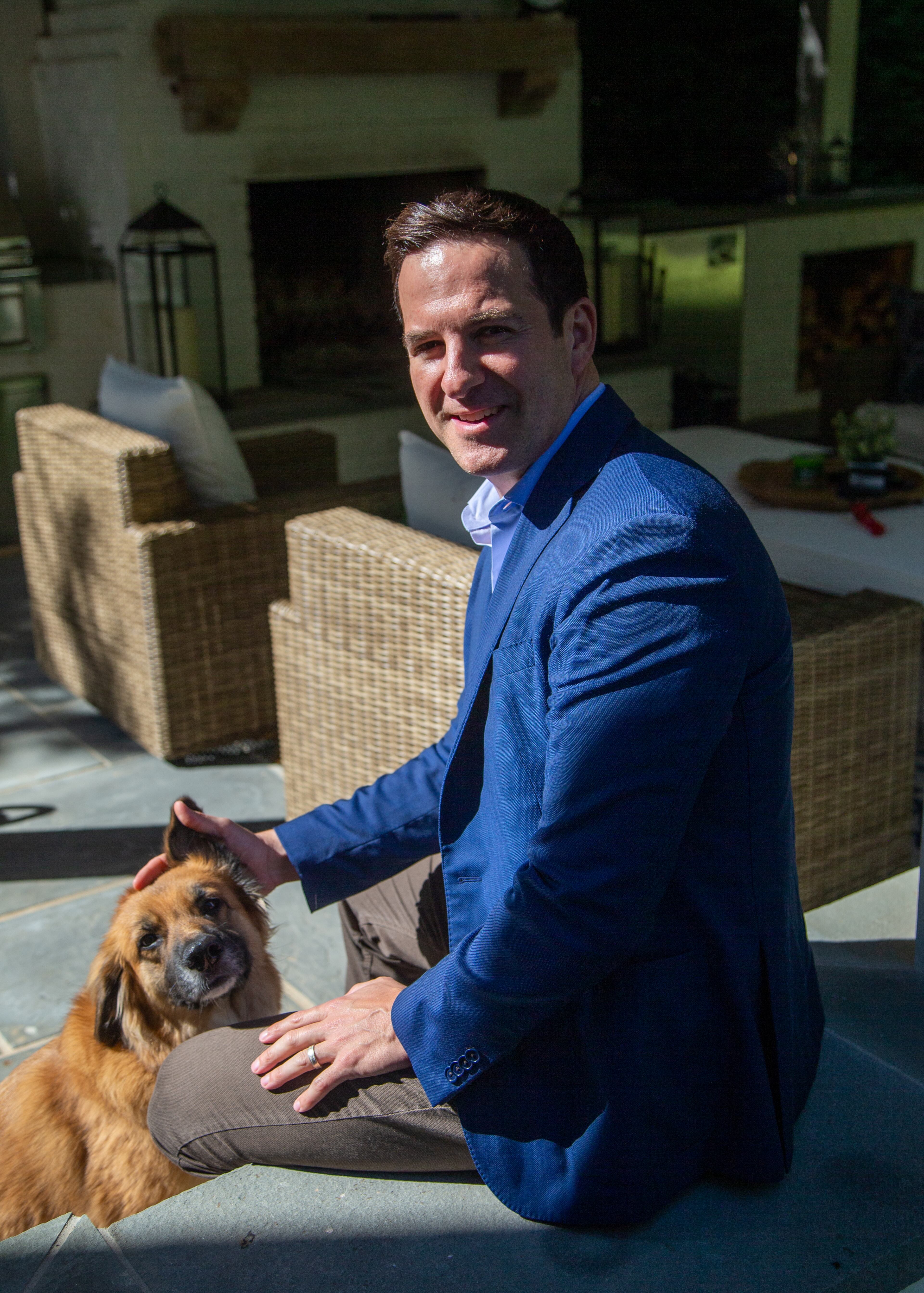 Ryan Cone with his dog Kiya at his Brookhaven home. PHIL SKINNER FOR THE ATLANTA JOURNAL-CONSTITUTION.