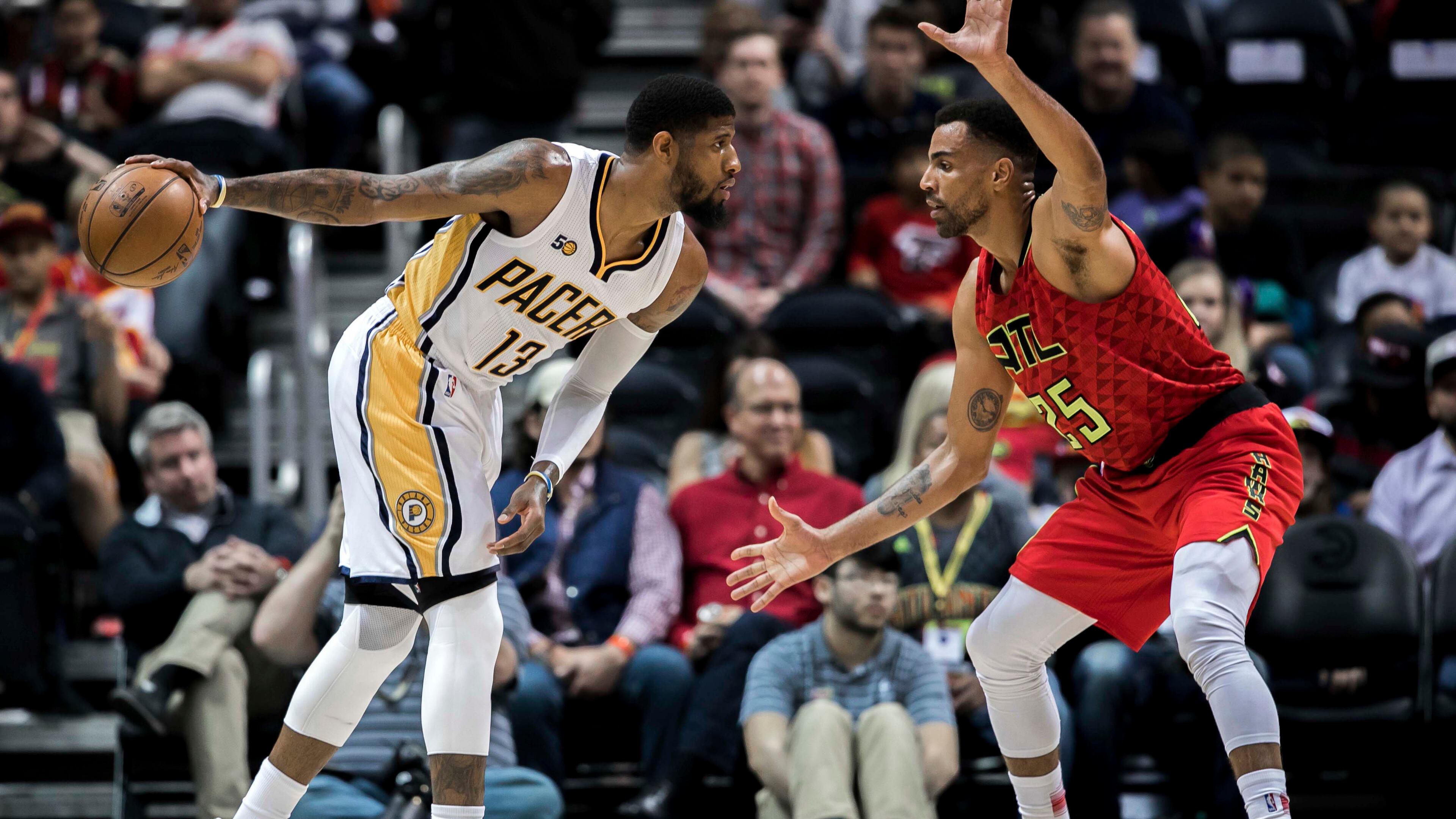 Indiana Pacers forward Paul George (13) controls the ball while defended by Atlanta Hawks forward Thabo Sefolosha (25) during the first quarter of an NBA basketball game, Sunday, March 5, 2017, in Atlanta. (AP Photo/Branden Camp)