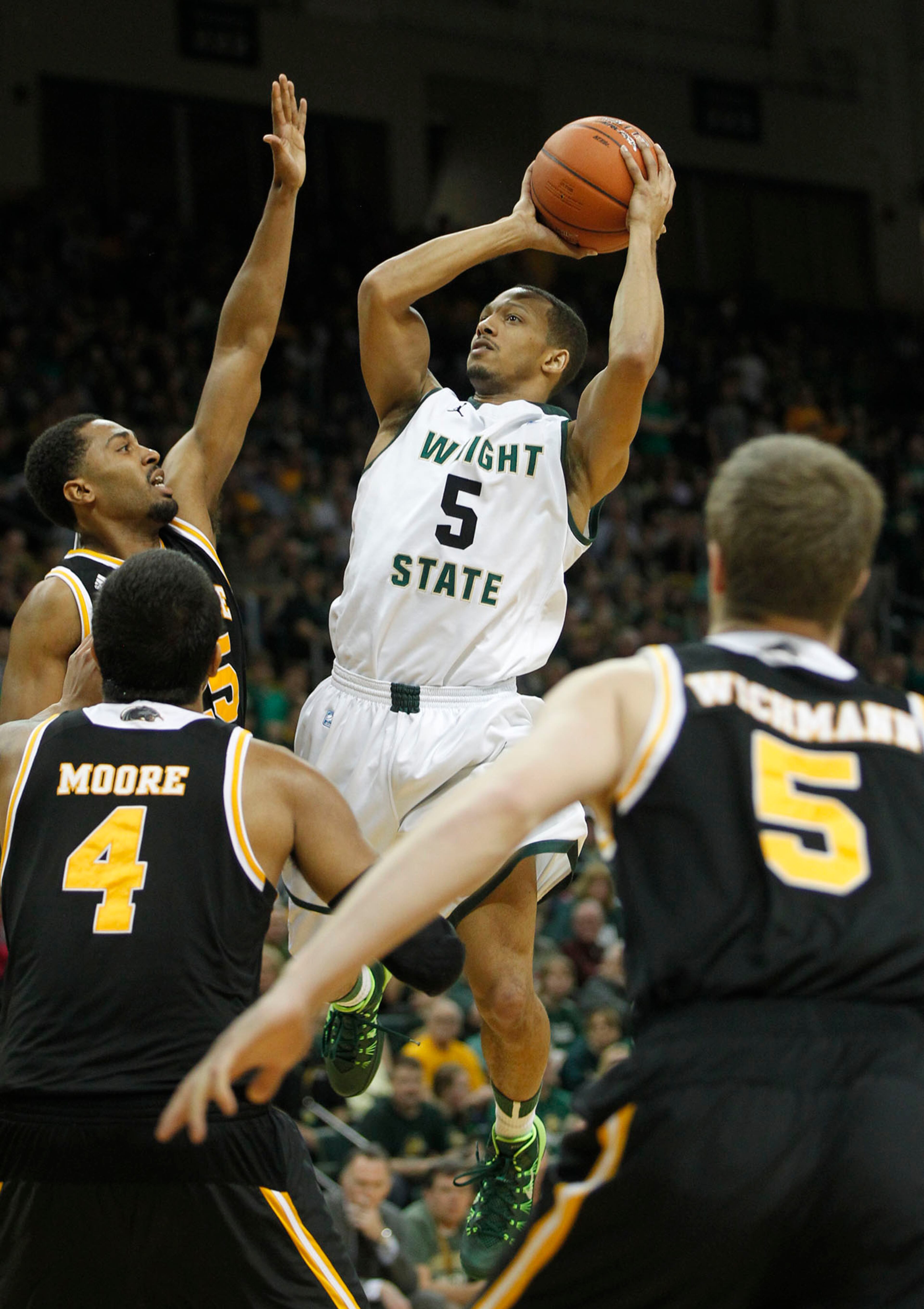 Wright State's Miles Dixon up for a jumper during the first half as the Raiders hosted the Panthers for the Horizon League Championship. Score at the half is Raiders 33, Panthers 43. TY GREENLEES / STAFF