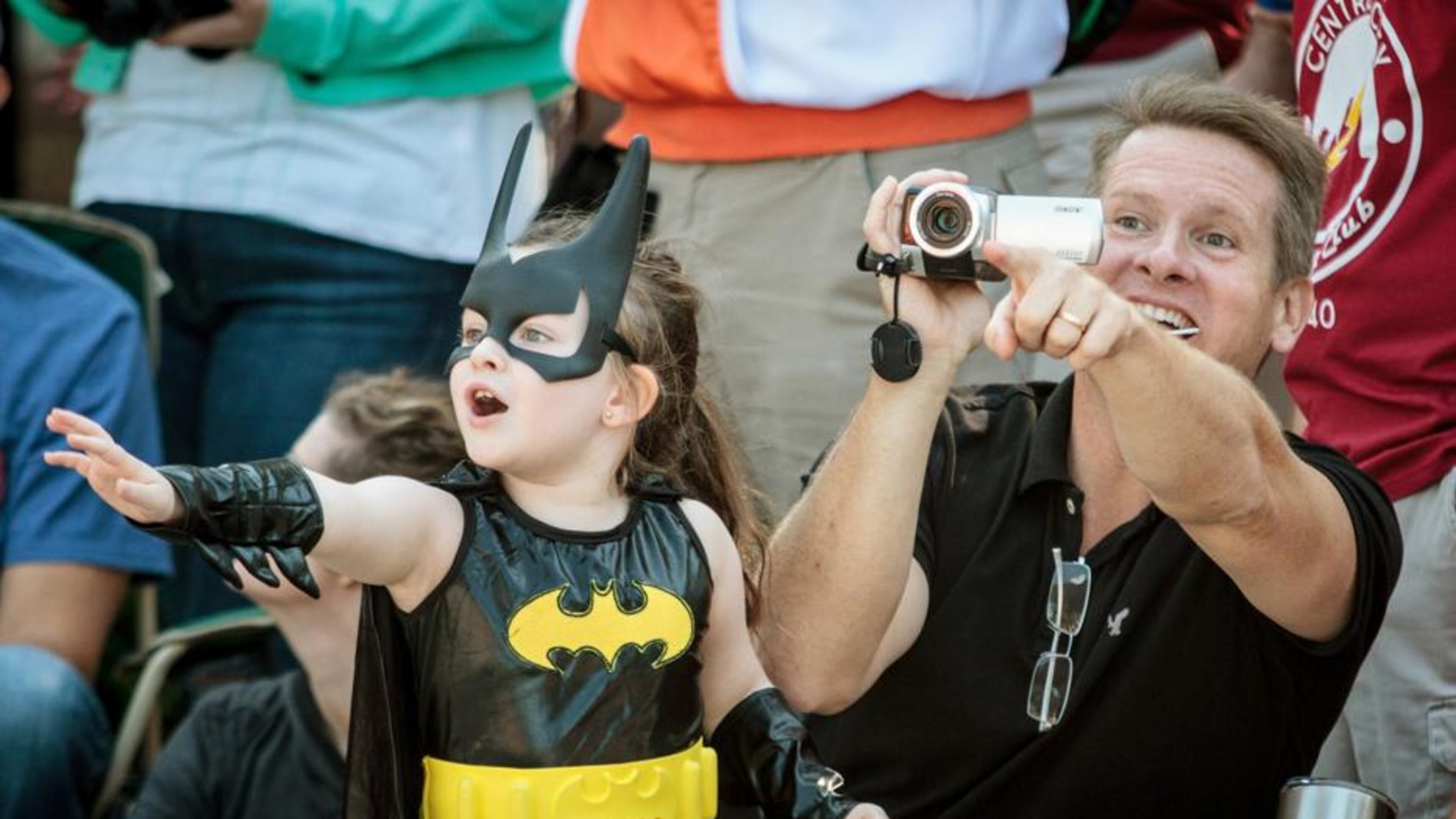 Steve Prater and his daughter Adrianna wave to their favorite characters during the Dragon Con parade in Atlanta on Saturday, Sept. 2, 2017.
