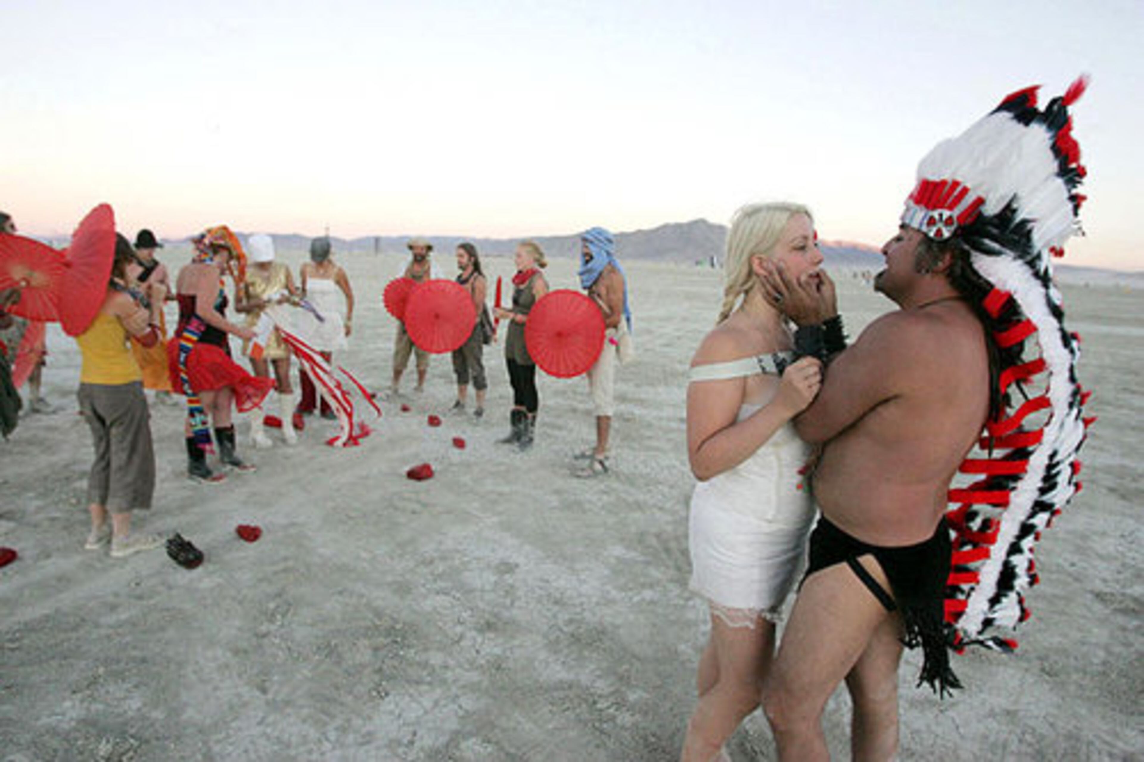 Alberto "BBoyB" Trevino prepares to kiss Vera Napoleon of Chicago after getting married during the Burning Man festival.