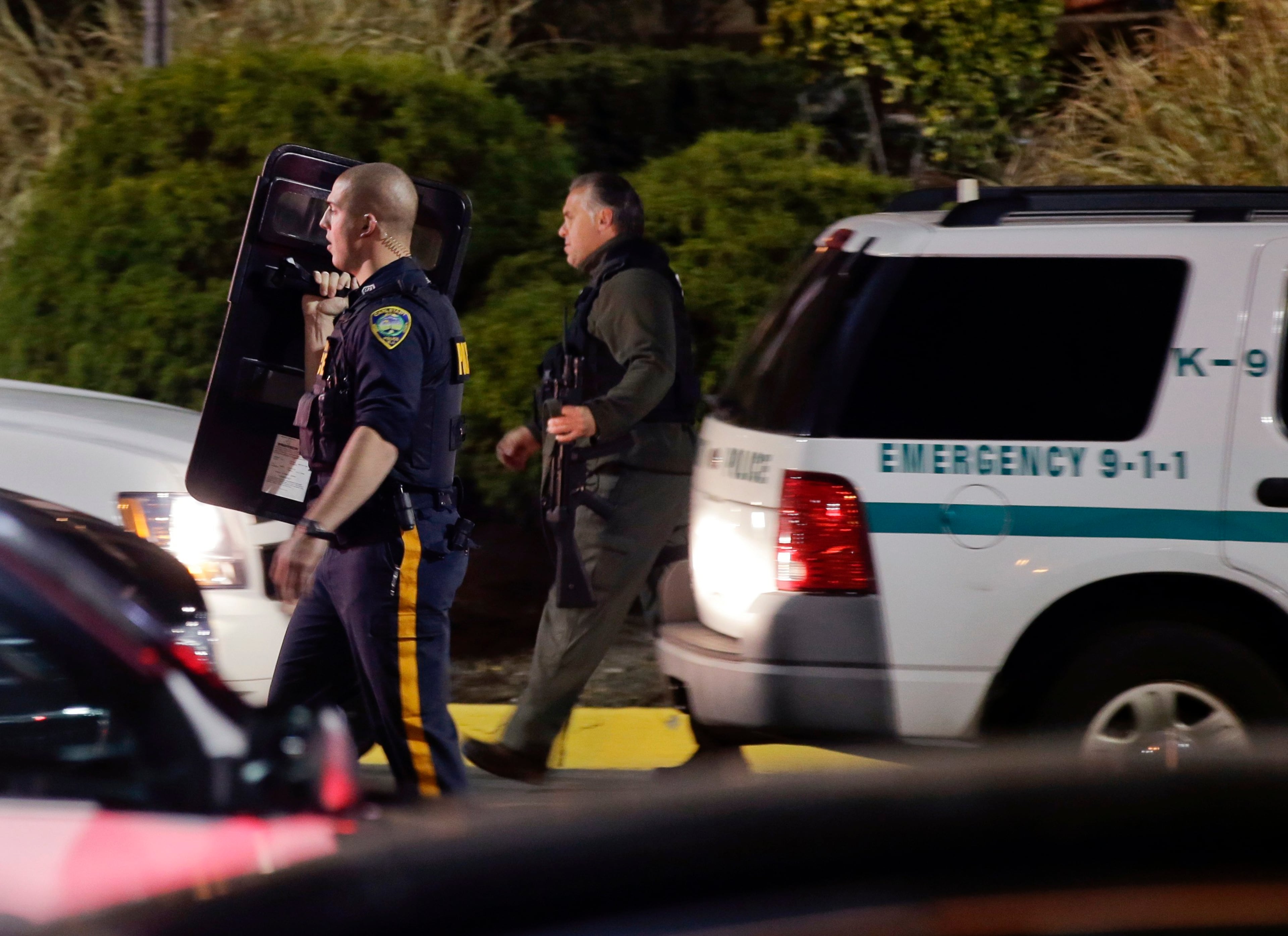 Police holding a shield and an automatic rifle patrol after reports that a gunman fired shots at the Garden State Plaza mall in Paramus, New Jersey, November 4, 2013. A person with a gun opened fire on Monday evening in the New Jersey shopping mall shortly before closing time in the town of Paramus, and the mall was being evacuated, a county official said. REUTERS/Ray Stubblebine
