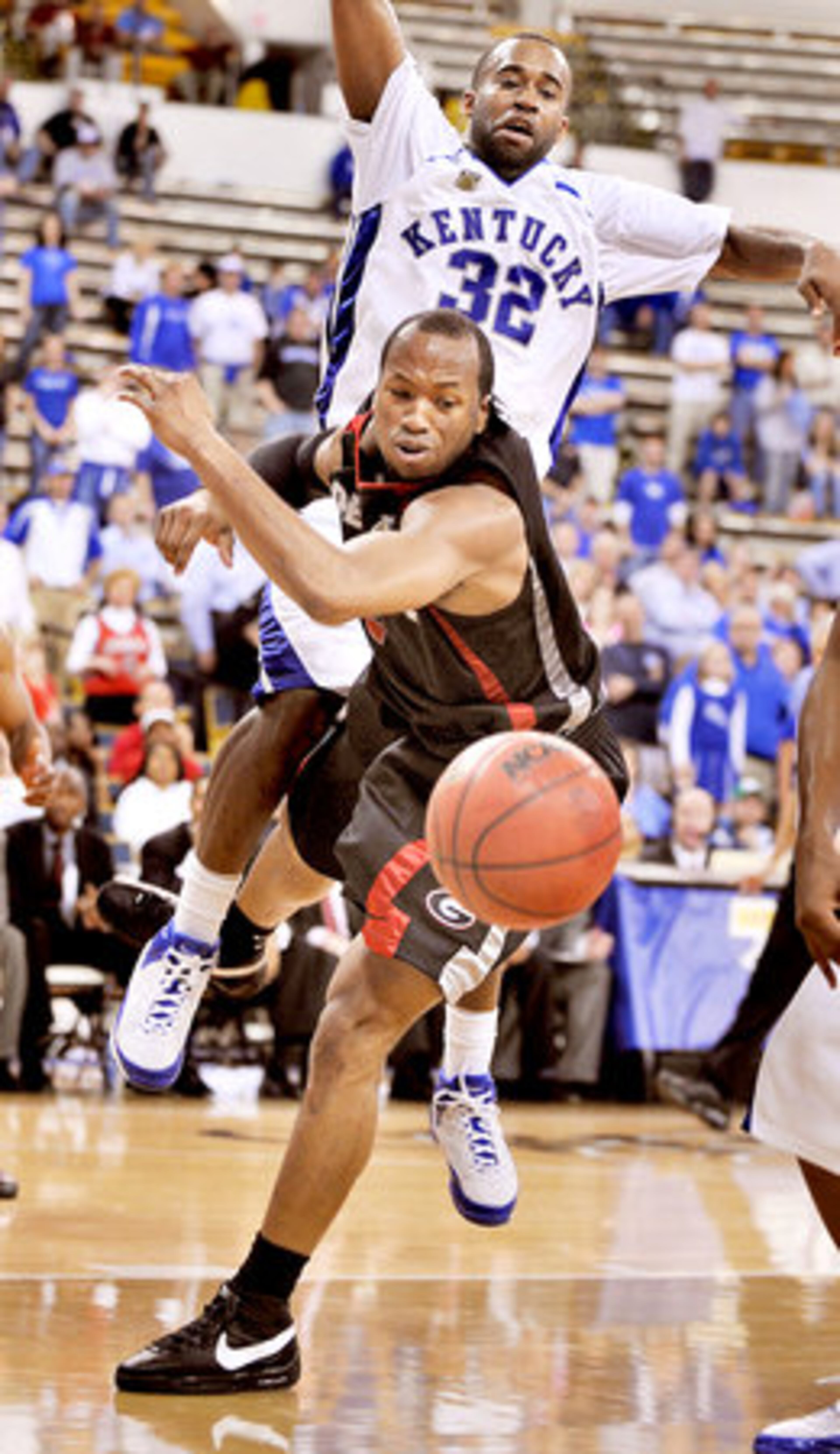 Georgia's Sundiata Gaines (front) is rejected by Kentucky's Joe Crawford.