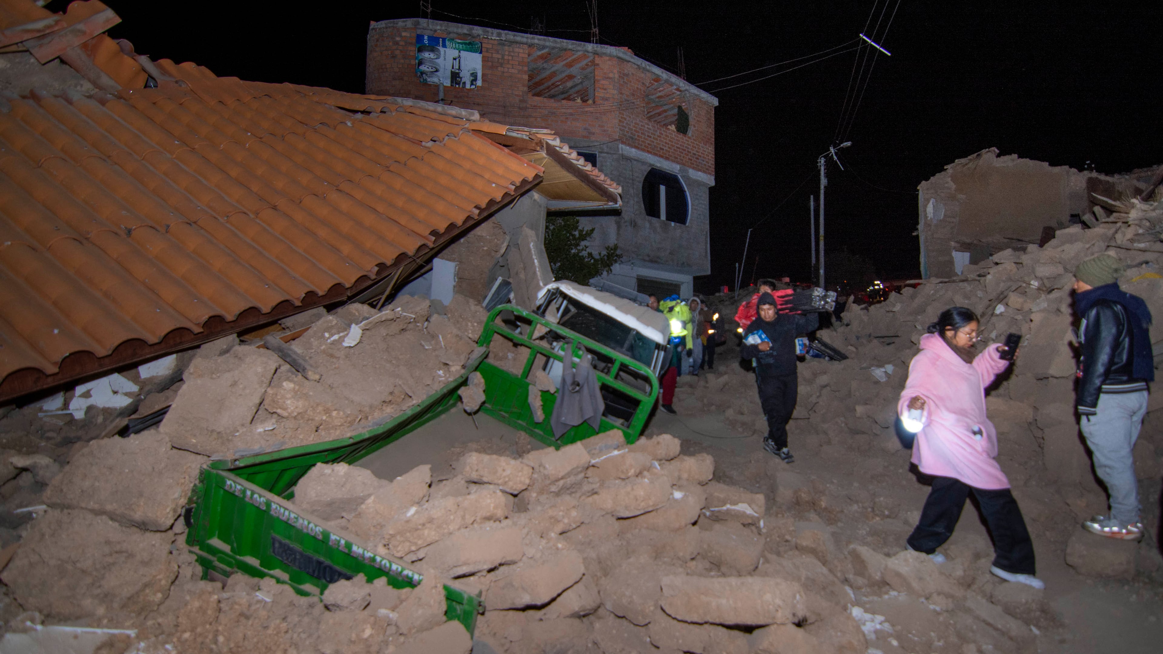 Residents walk amid the debris of homes that collapsed after an earthquake struck Pumpuya, Peru, Sunday, July 19, 2026. ( AP Photo/Javier Ninanya)