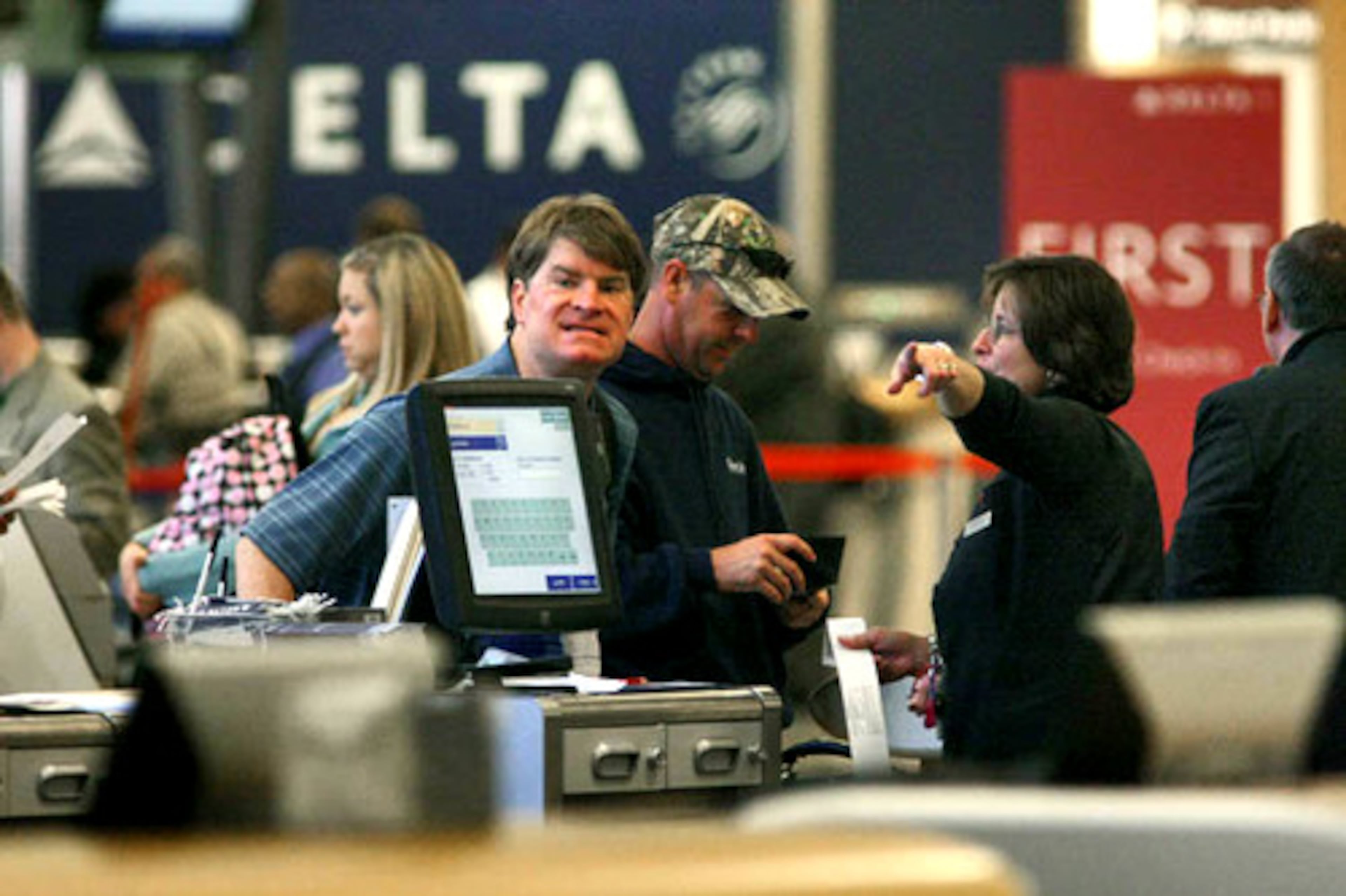 Michael Eckardt gets ready to fly to Orlando Tuesday from the Delta ticket counter. He said of the merger, "I like it - it's positive. I didn't want to see Northwest get the hub."