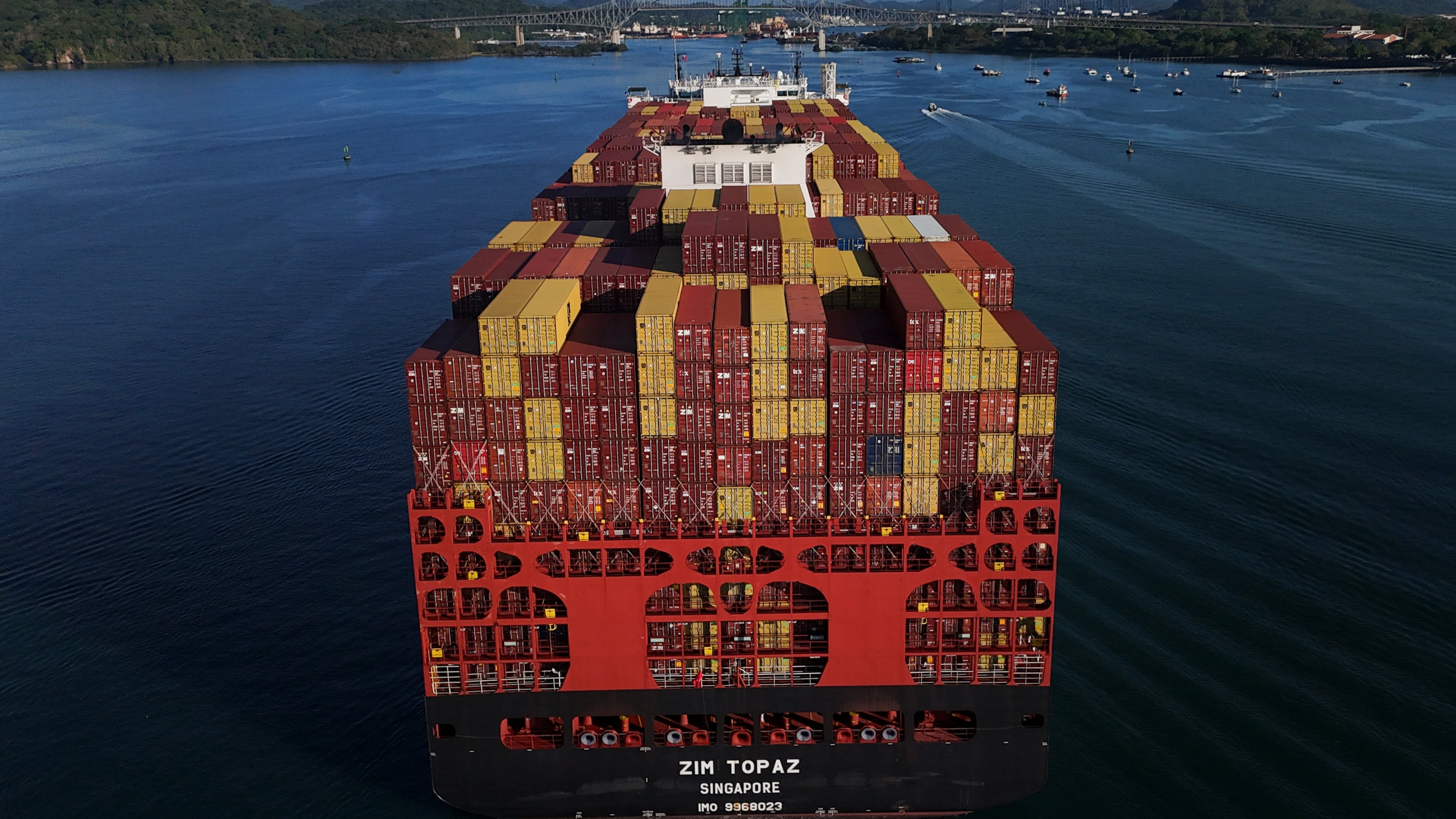 Cargo containers are stacked on a cargo ship moving through the Panama Canal, at sunrise in Panama City, Wednesday, March 25, 2026. (AP Photo/Matias Delacroix)