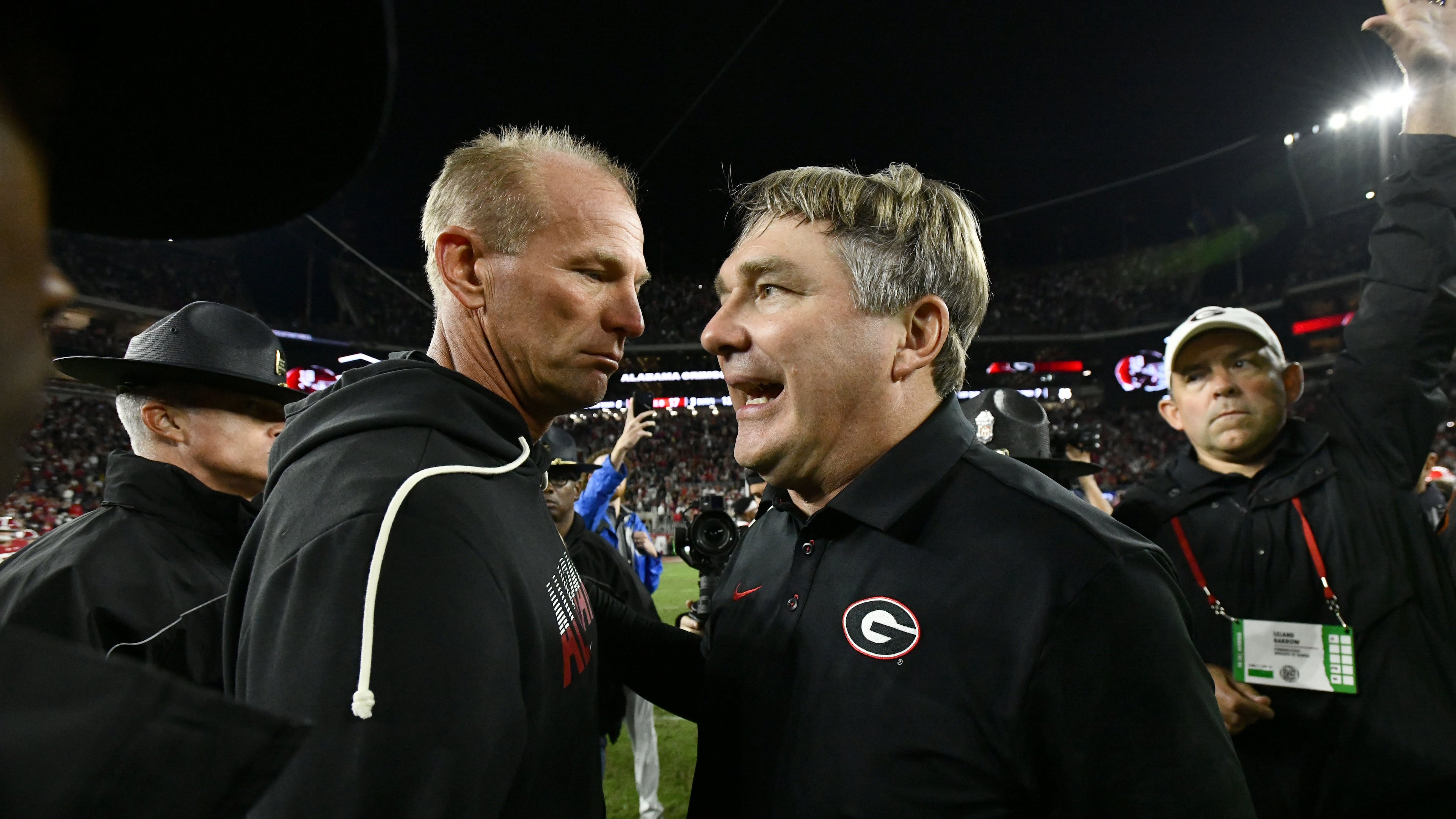 Georgia coach Kirby Smart (right) and Alabama coach Kalen DeBoer shake hands after Georgia defeated Alabama 20-17 on Saturday, Oct. 10, 2026, at Bryant-Denny Stadium in Tuscaloosa, Alabama. (Hyosub Shin/AJC)
