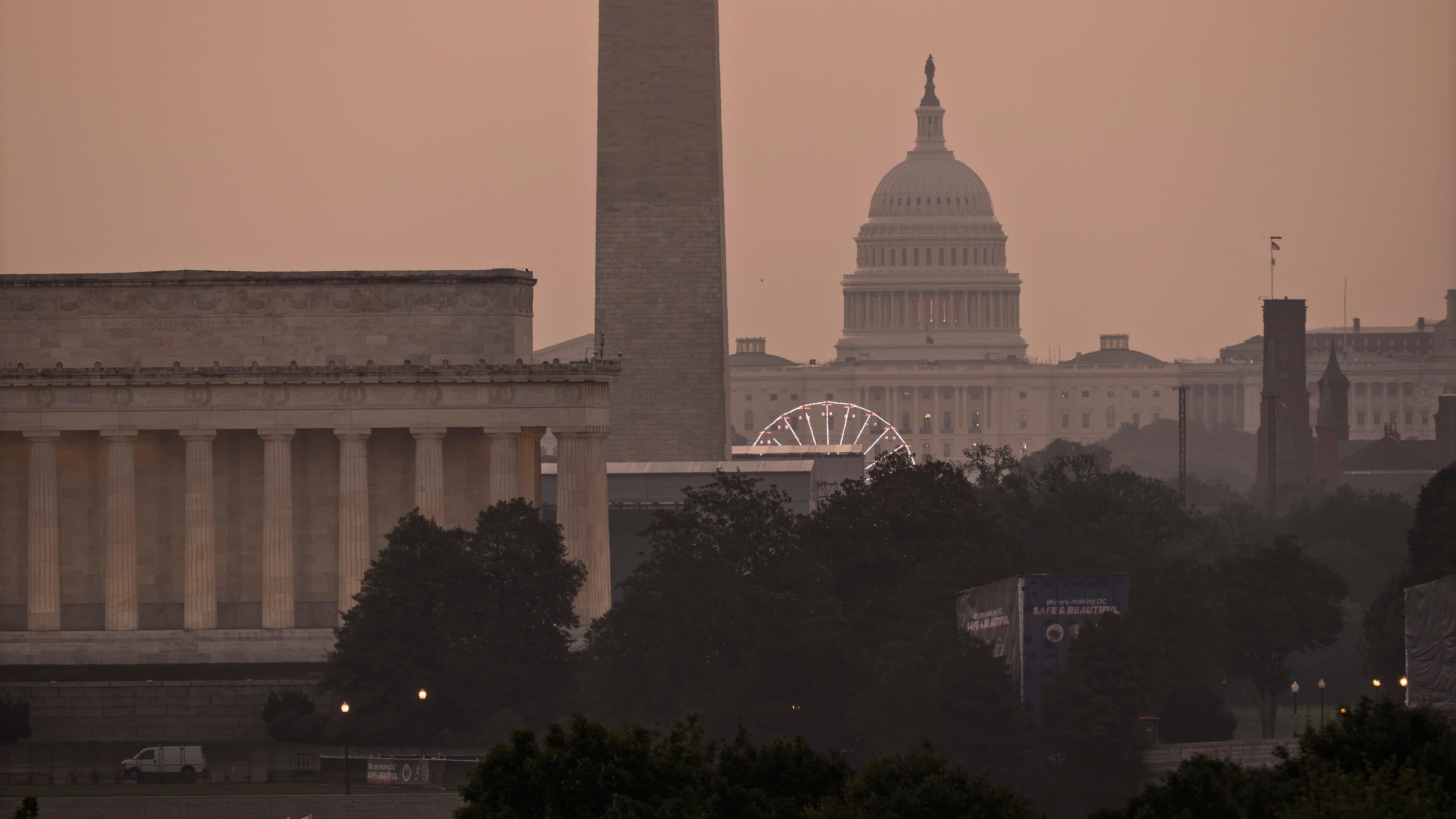 The Lincoln Memorial, the Washington Monument, and the U.S. Capitol, are seen at dawn from an overlook in Arlington, Va., as Washington prepares for sweltering temperatures, Friday, July 3, 2026. (AP Photo/J. Scott Applewhite)