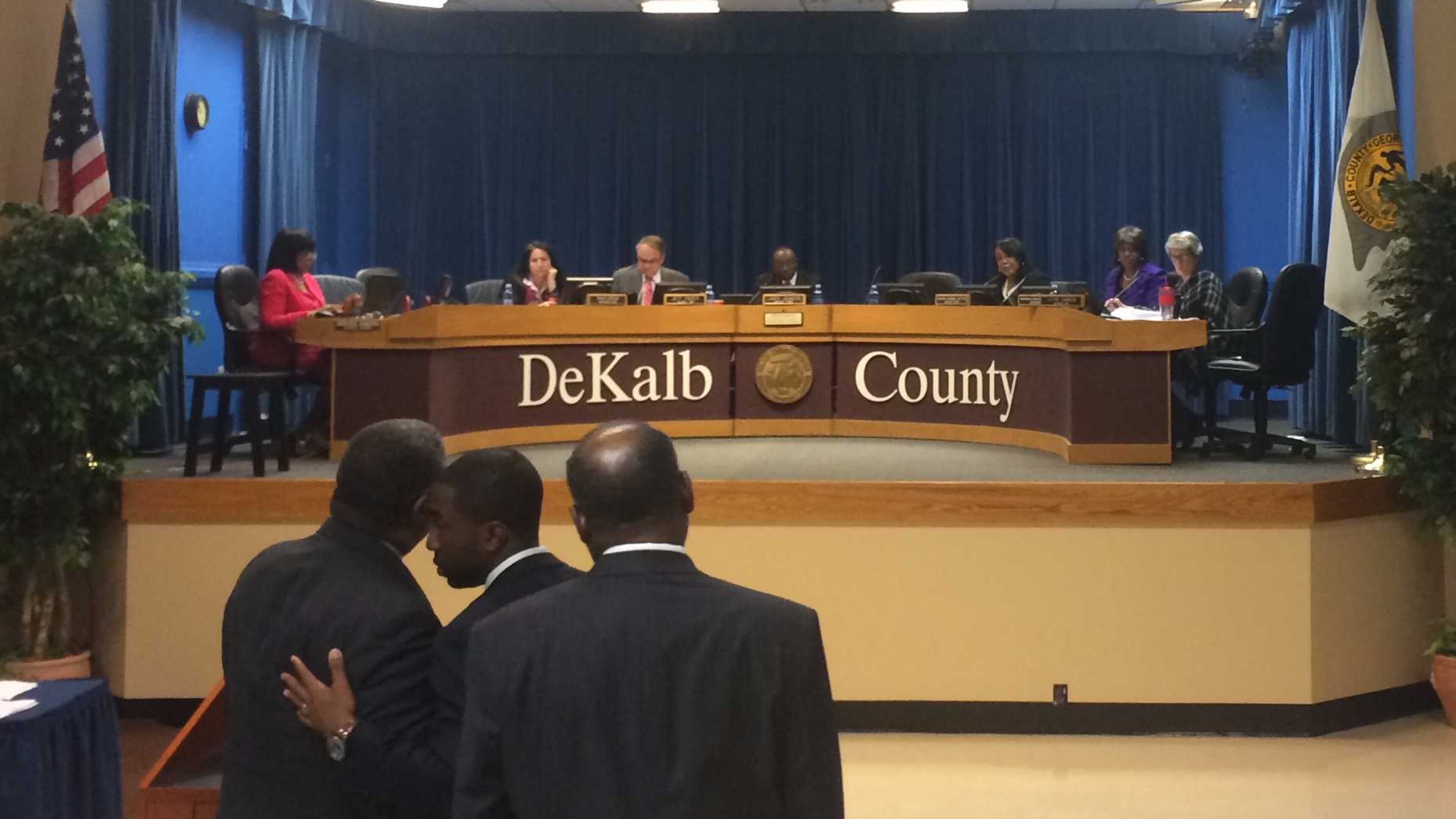 Interim DeKalb CEO Lee May, center, huddles with DeKalb COO Zach Williams, left, and DeKalb Community Development Director Allen Mitchell before the County Commission voted Tuesday to approve $1.6 million to complete construction of the North DeKalb Senior Center. MARK NIESSE / MARK.NIESSE@AJC.COM