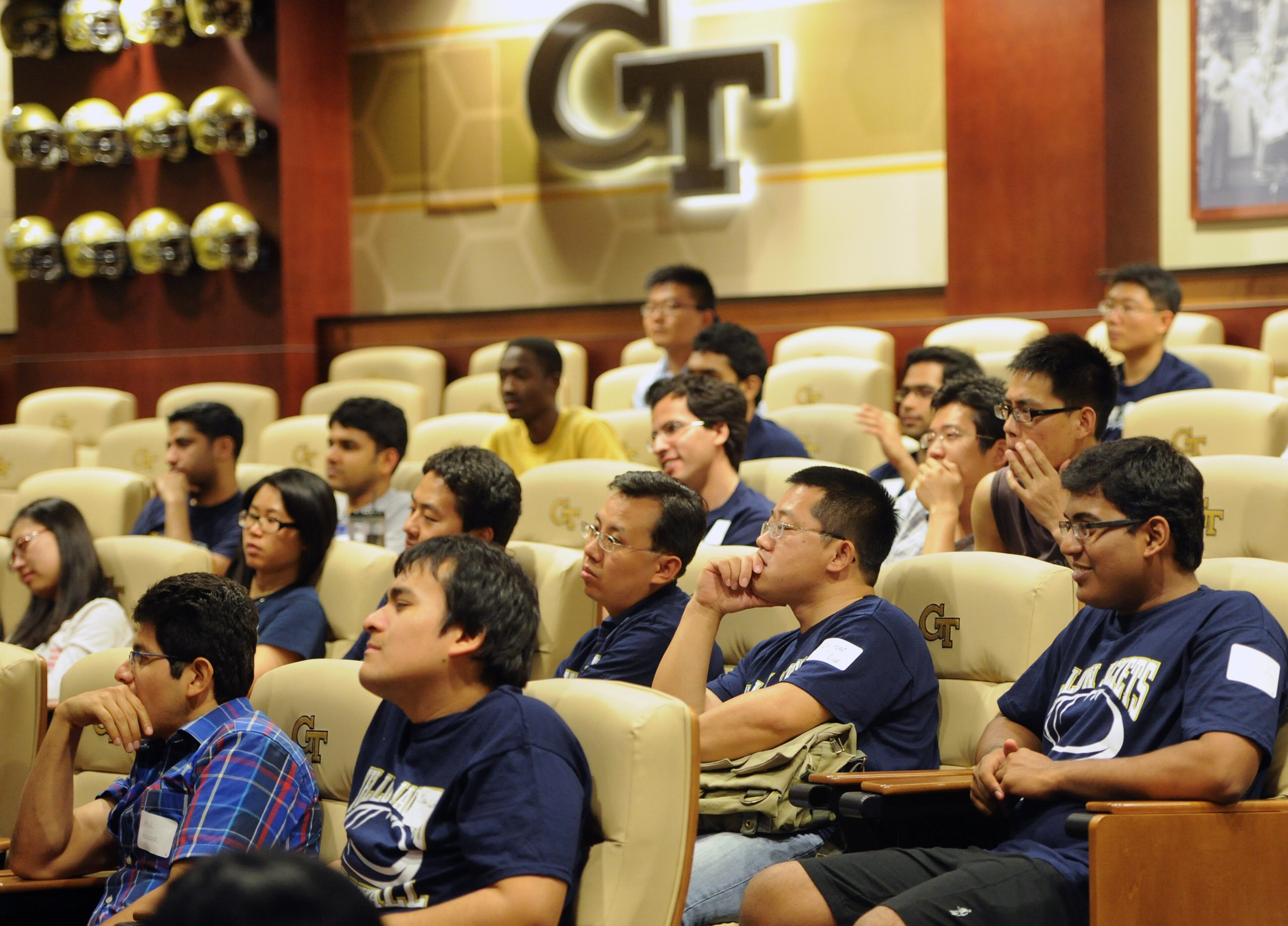 Students listen to Georgia Tech head coach Paul Johnson explain the game of football.