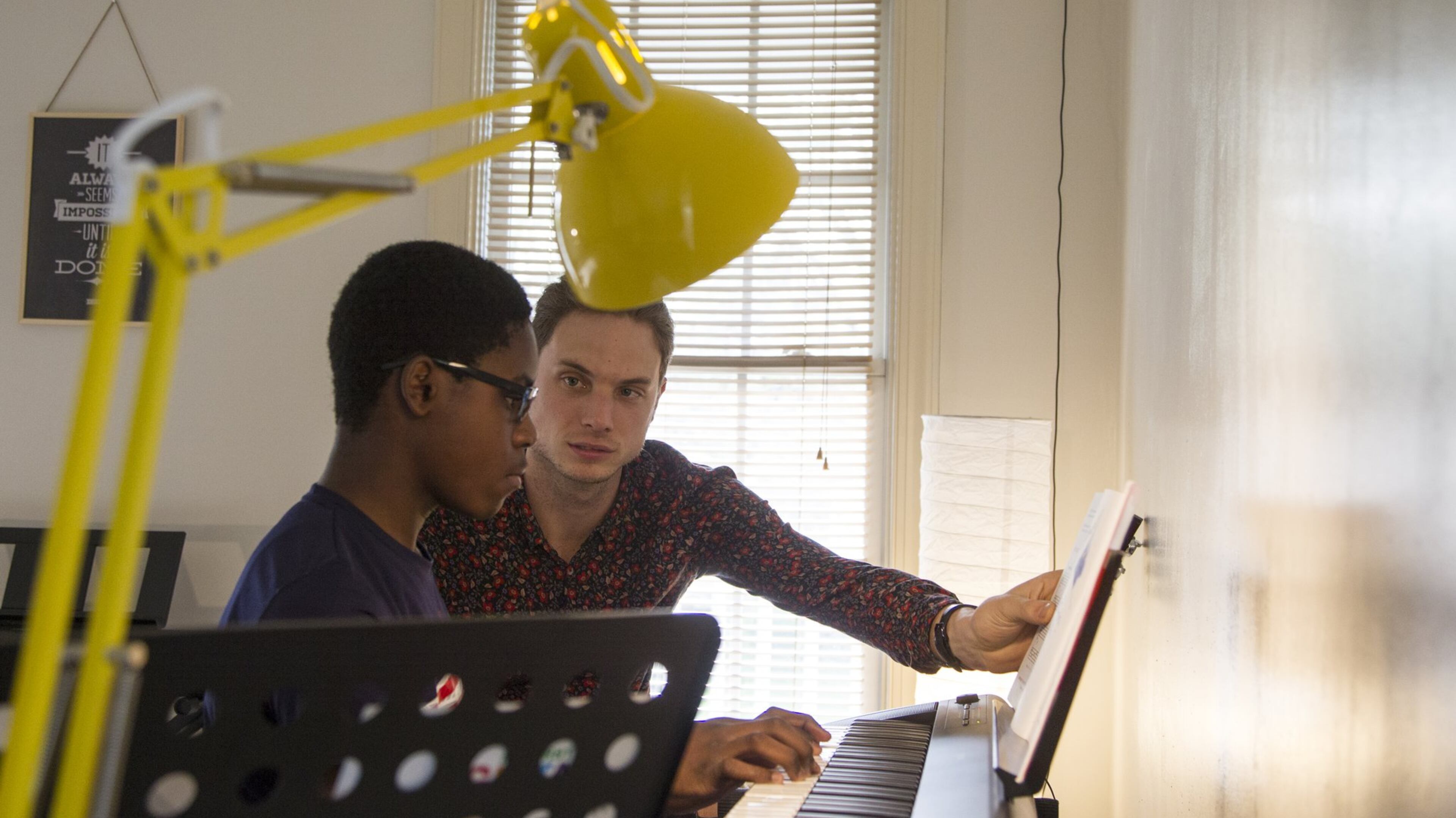James Shealy (right), a music instructor, gives MaKhi Haynes, a teen student in Atlanta, a piano lesson during an afternoon session of the Kevin Baker Music Program. The program is part of the Friends of English Avenue nonprofit, and it works with kids in the area to teach them how to play different musical instruments. REANN HUBER / REANN.HUBER@AJC.COM