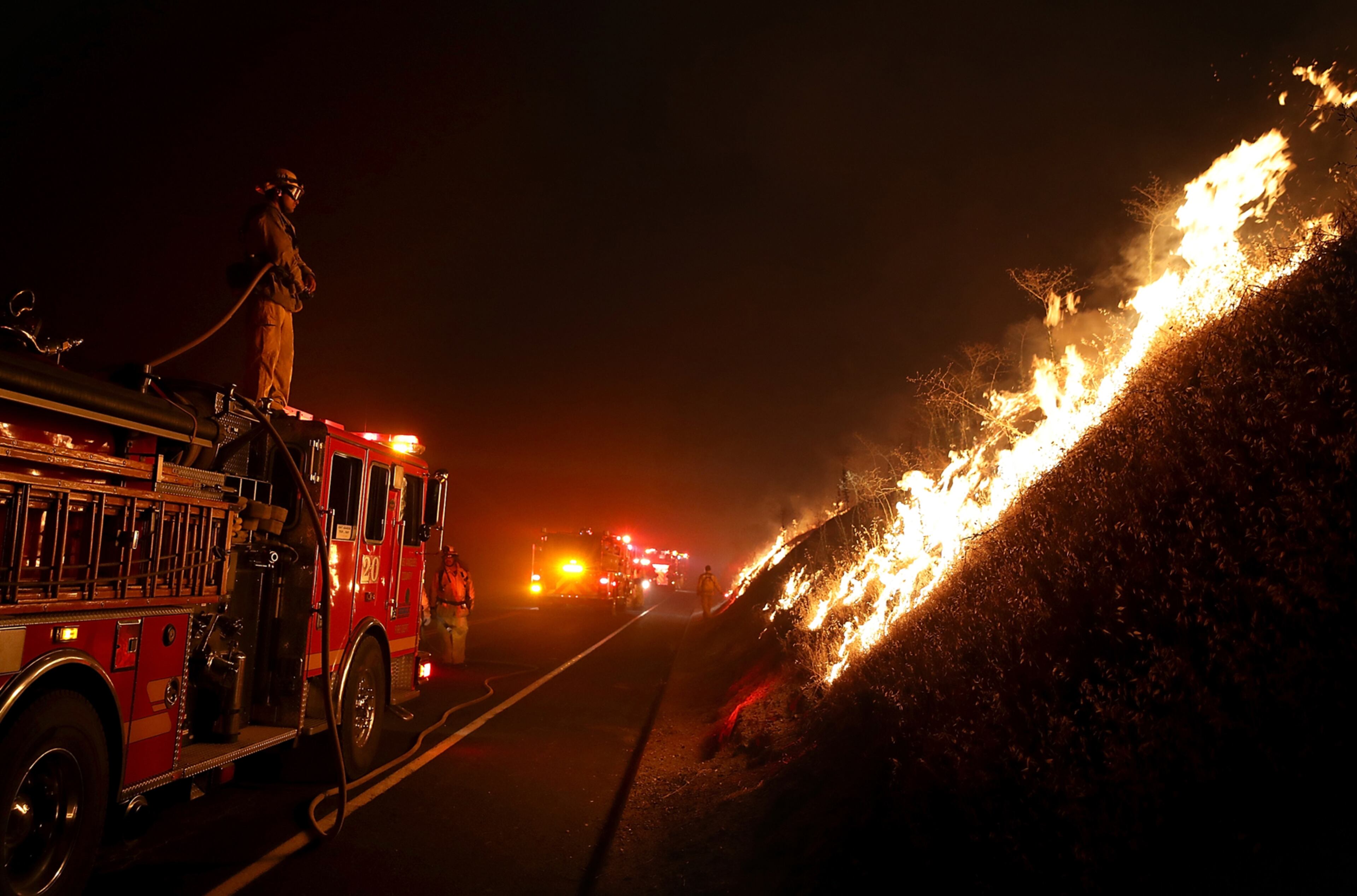 MARIPOSA, CA - JULY 18: A firefighter monitors the Detwiler Fire on July 18, 2017 in Mariposa, California. More than 1,400 firefighters are battling the Detwiler Fire that has burned more than 25,000 acres, forced hundreds to evacuate and destroyed at least 8 structures. The fire is five percent contained. (Photo by Justin Sullivan/Getty Images)