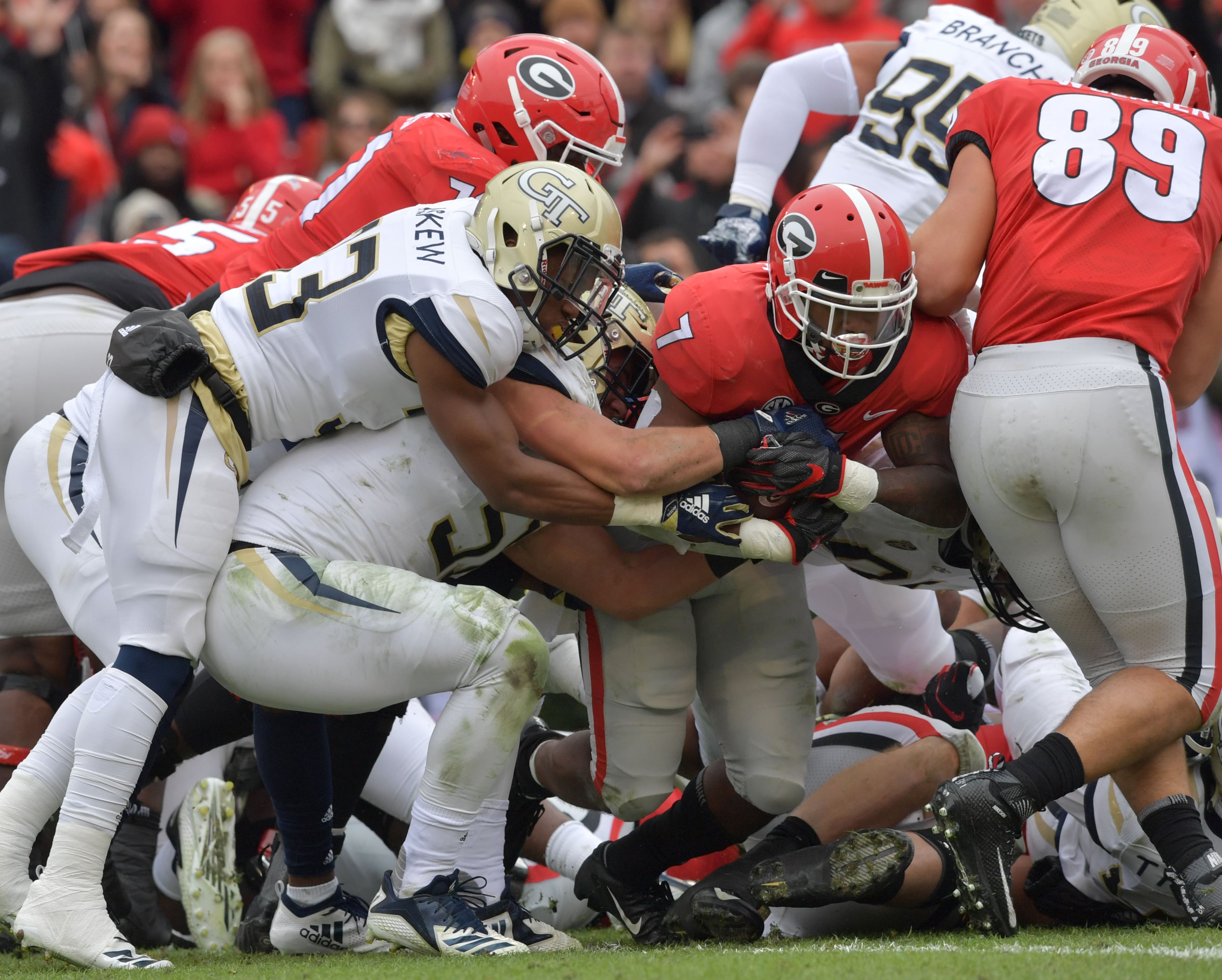 November 24, 2018 Athens - Georgia running back D'Andre Swift (7) scores a touchdown as Georgia Tech defenders try to stop him during the first half in a NCAA college football game at Sanford Stadium on Saturday, November 24, 2018. HYOSUB SHIN / HSHIN@AJC.COM