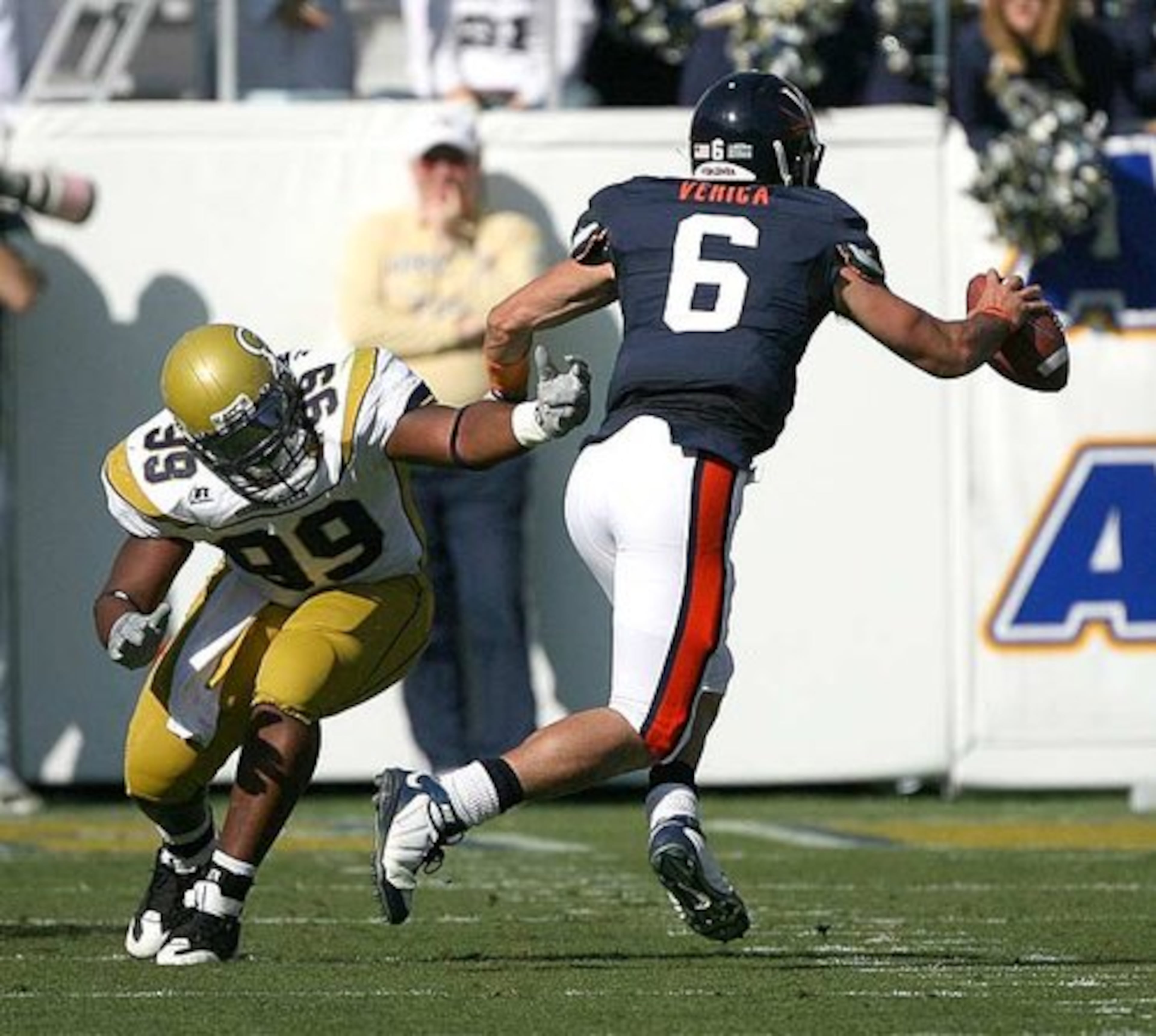 Georgia Tech's Vance Walker grabs air as Virginia quarterback Marc Verica avoids a sack in the first quarter.